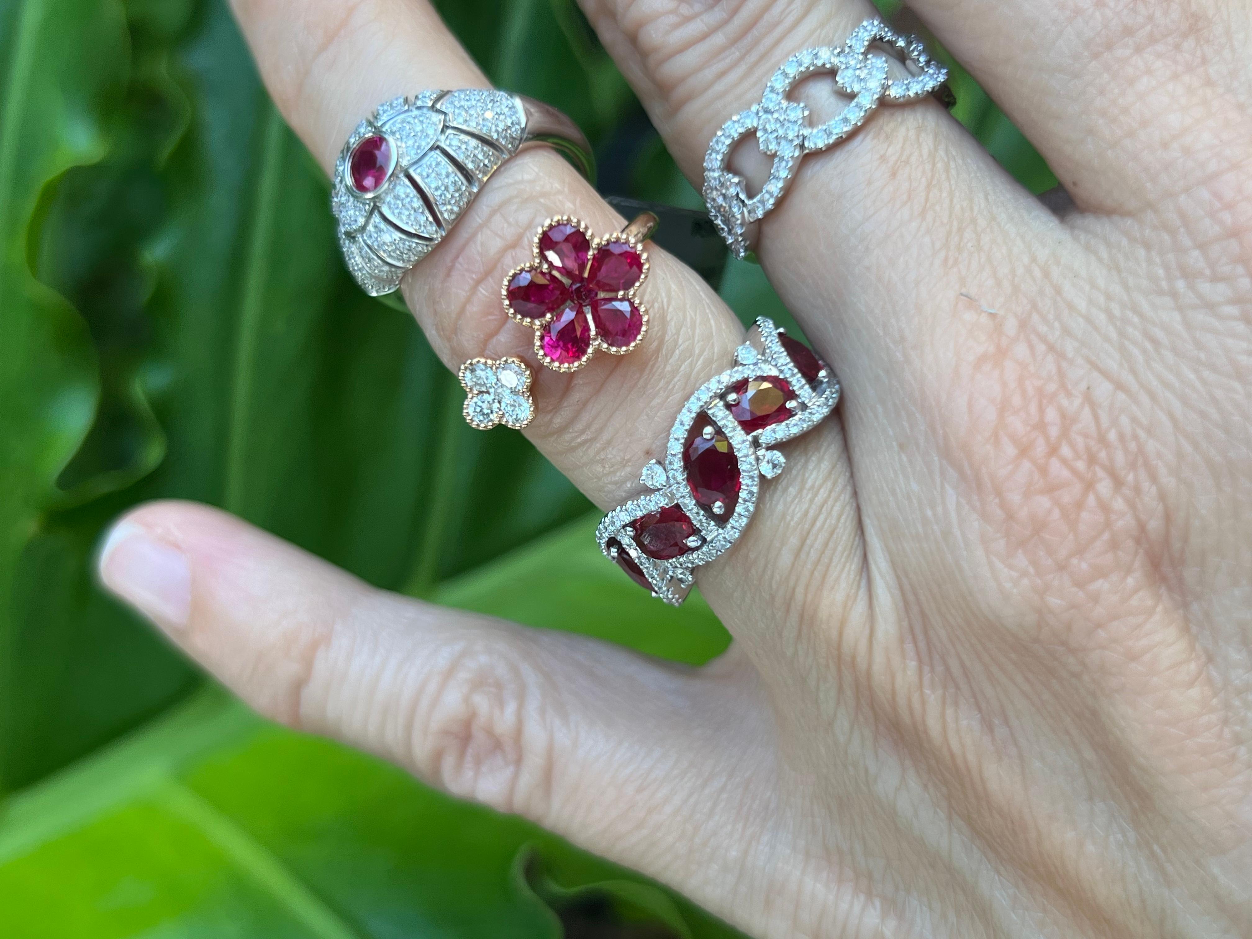 Oval rubies mounted on prongs create a whimsical vine design accented with diamonds on 18K white gold. 

Features
18K white gold
1.70 carat total weight in rubies
0.42 carat total weight in diamonds
Ring size 6. Can be sized 2 numbers up or down