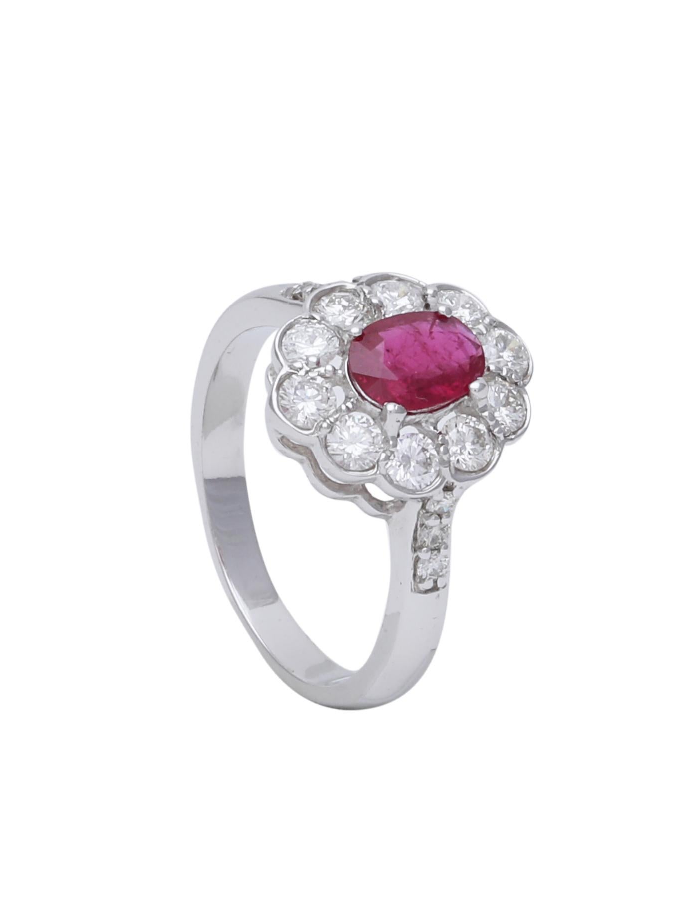 A simple and chic engagement ring with a Ruby Oval centre and a Diamond Halo around, beautifully set in 18K White Gold. The special setting of the diamonds make them look bigger than they are and makes the appearance of the ring also bigger.

The