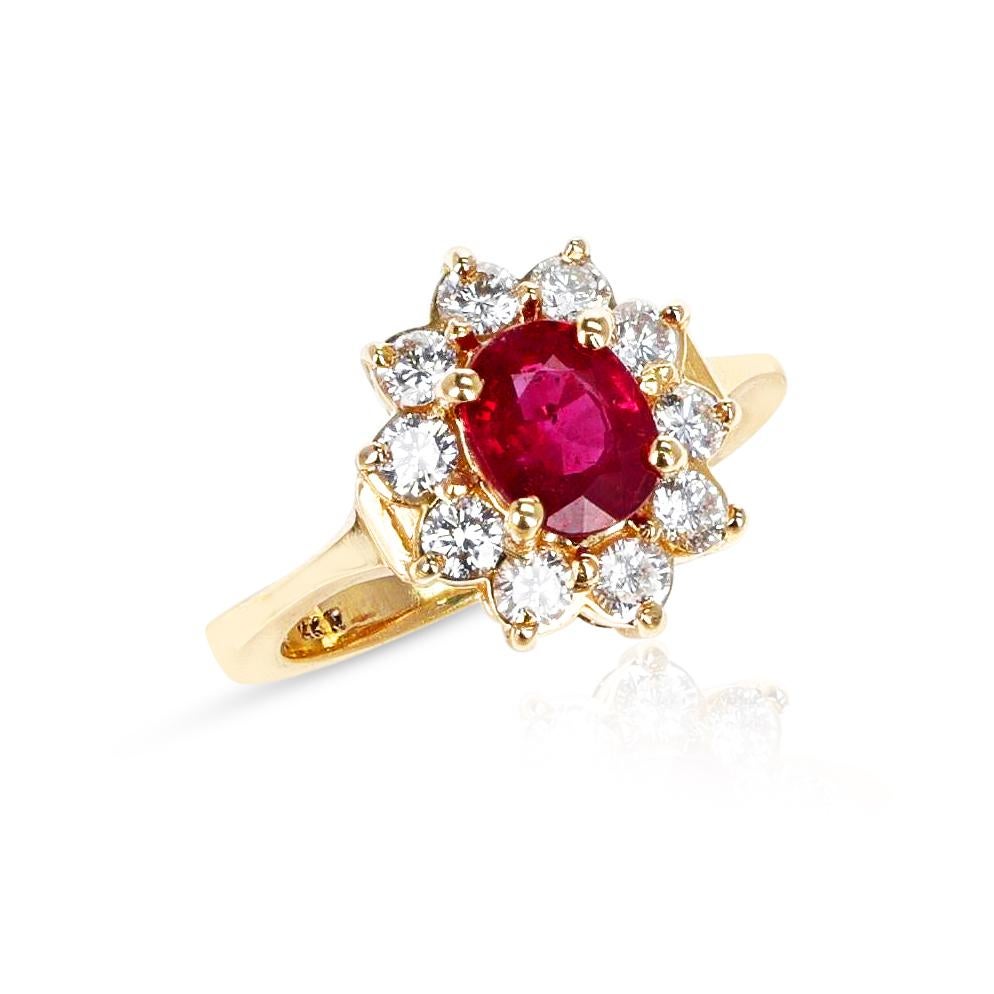 A 1.25 carat Oval Ruby and Diamond Cluster Ring made in 18 Karat Yellow Gold. The ring size is US 6.5 US. The total weight of the ring is 5 grams.