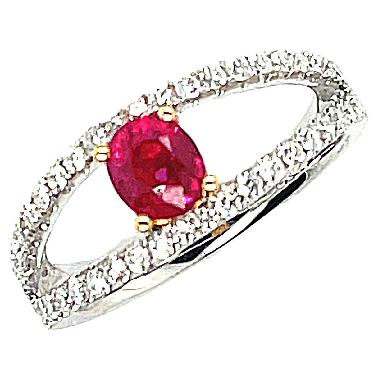 This beautiful cocktail ring features a sparkling red ruby and brilliant-cut diamonds set in 18k white and yellow gold. The ruby weighs .68 carat, has vivid red color, and is so full of life! We have set the ruby in 18k yellow gold, allowing it to