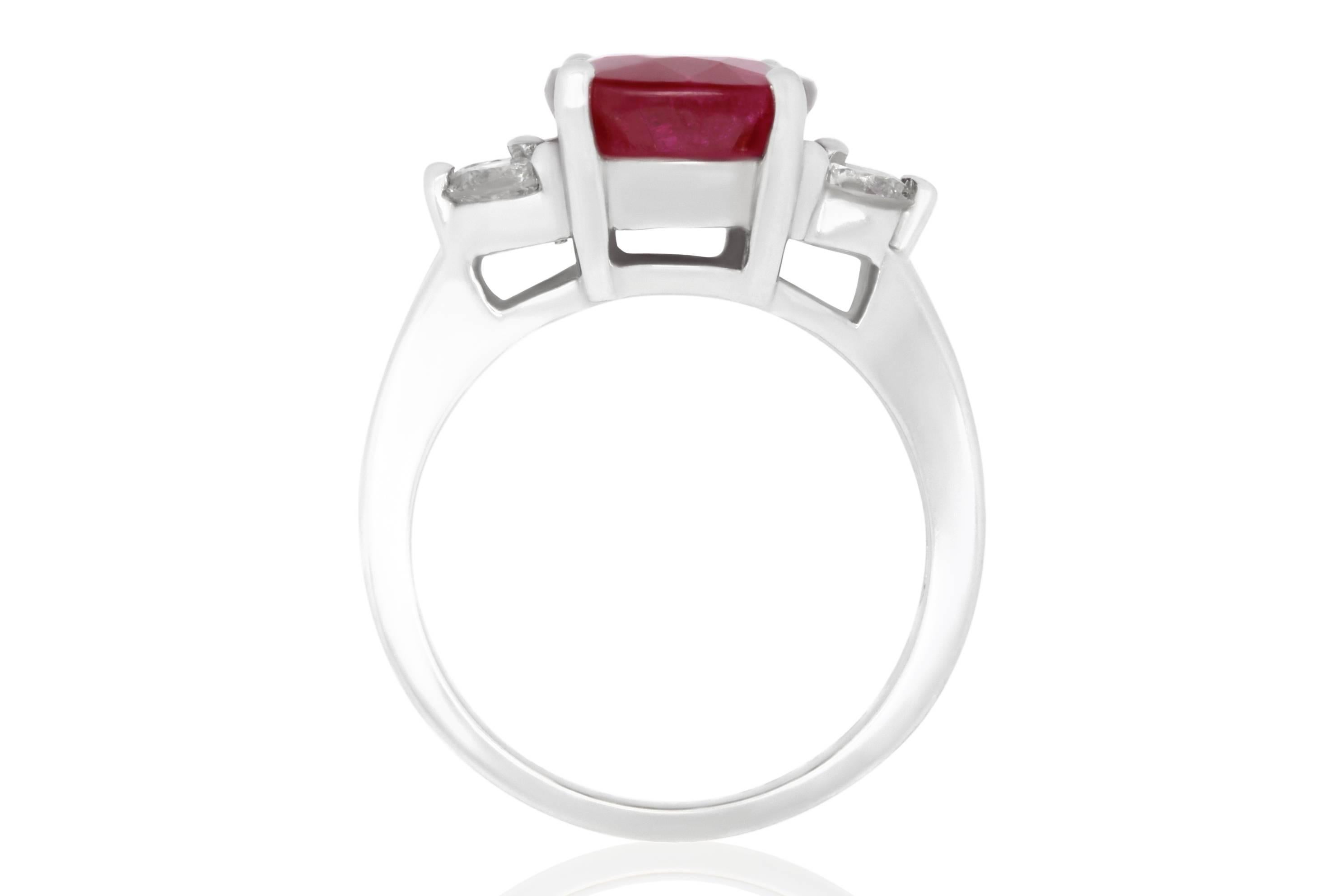 Material: 18k White Gold
Gemstones: 1 Oval Ruby at 5.24 Carats. Measuring 9 x 7 mm.
Diamonds: 4 Brilliant Round White Diamonds at 0.57 Carats. SI Clarity / H-I Color. 
Ring Size: 6.5. Alberto offers complimentary sizing on all rings.

Fine one-of-a