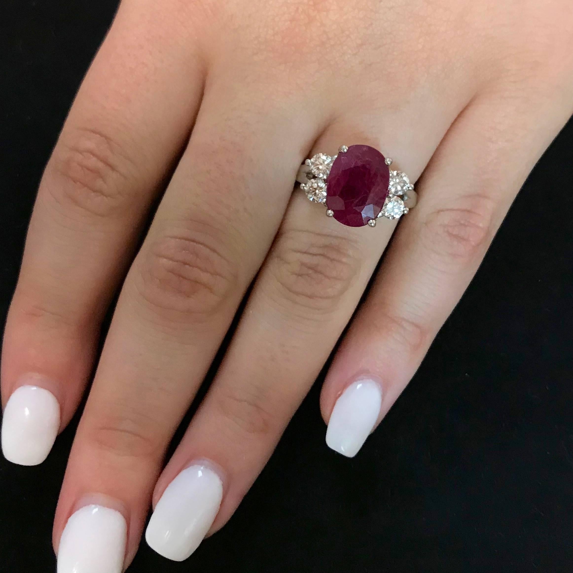 Oval Ruby and Diamond Side Stone Engagement Ring in 18K White Gold 
