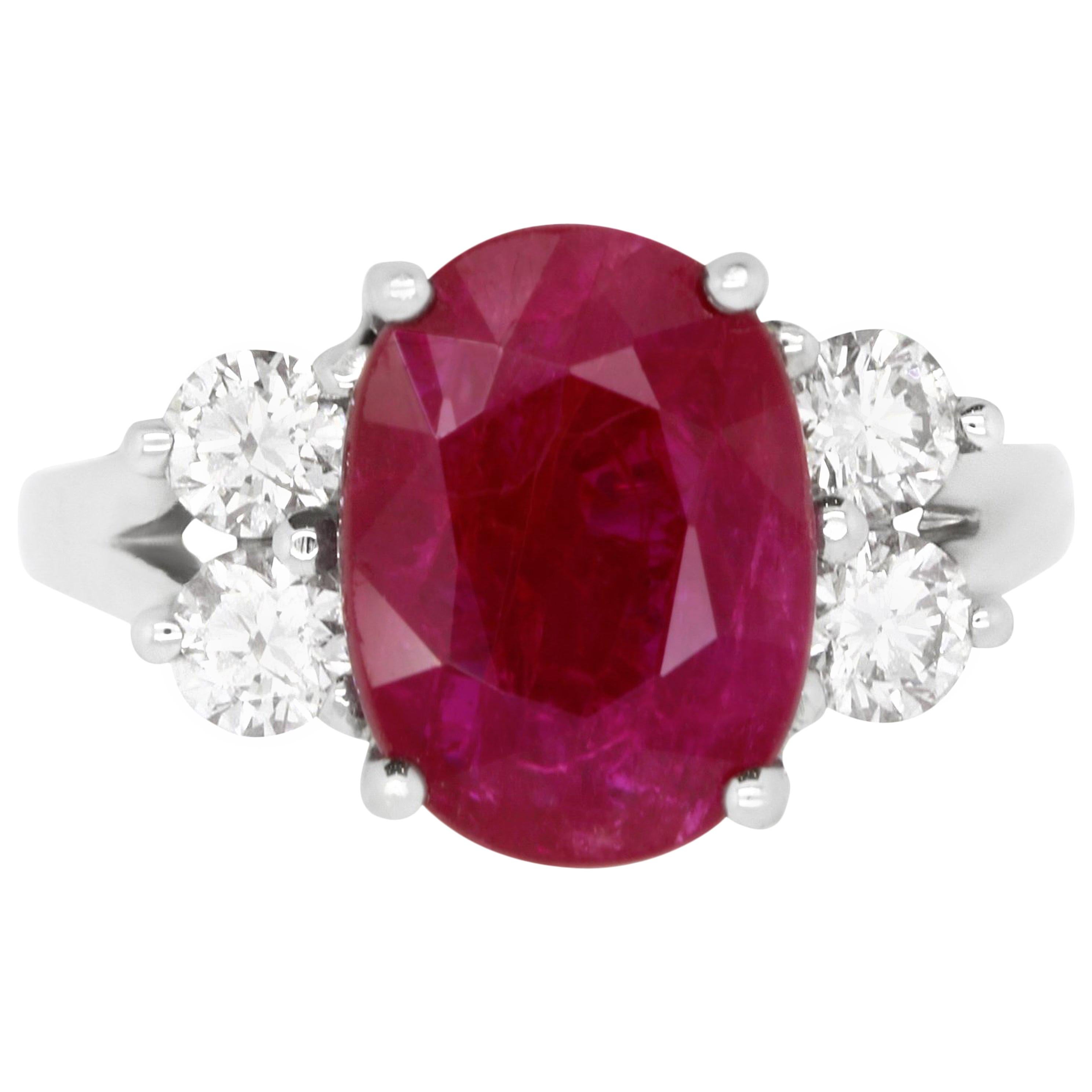 Oval Ruby and Diamond Side Stone Engagement Ring in 18K White Gold
