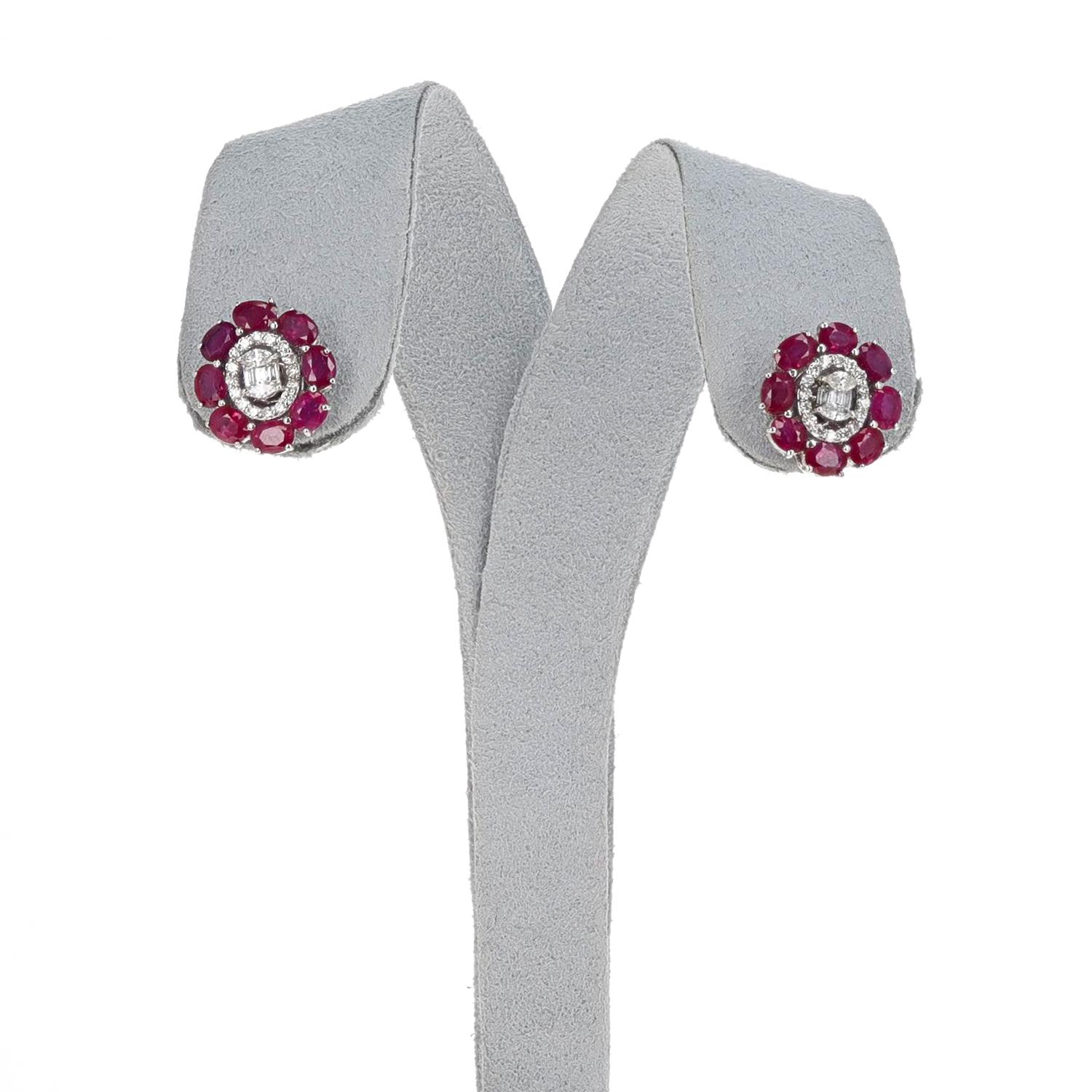 A pair of Oval Ruby and Diamond Stud Earrings made in18k White Gold. The rubies weigh 3.64 carats and the diamonds weigh 0.45 carats. The earrings weigh 6.14 grams. The dimensions are 0.55
