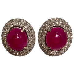 Striking 6 Carat Oval Ruby Cabochon Triple Diamond Halo White Gold Post Earrings