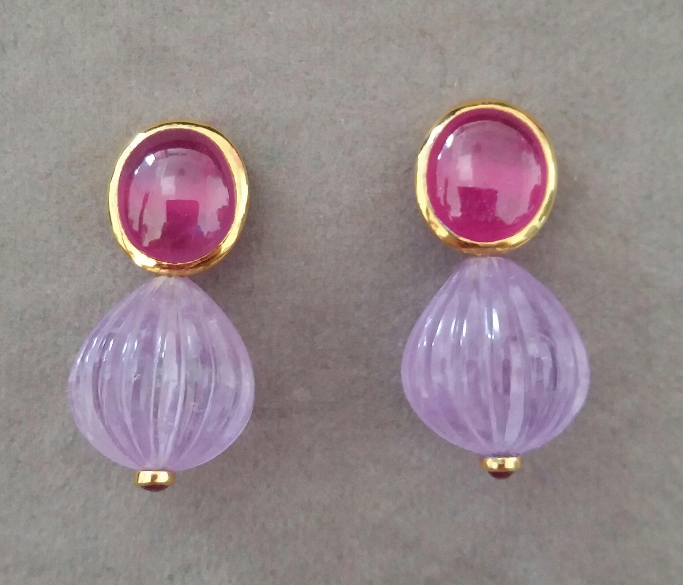 In these simple chic and handmade stud earrings we have  a pair of Oval Ruby cabochons size 10 x 12 mm set in 14 kt solid yellow gold bezel on the top and 2 Natural Amethyst carved round drops measuring 15x16mm with 2 small round ruby cabs set in