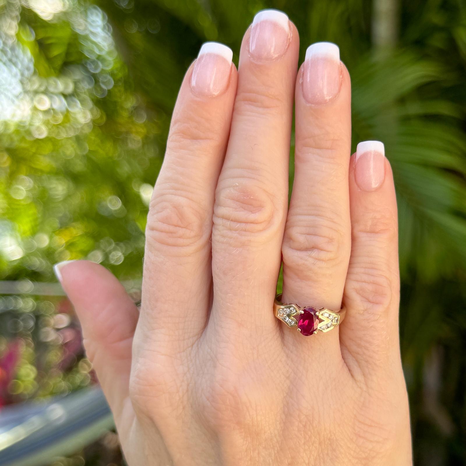 This vintage ring exudes classic charm and elegance with its captivating design. Crafted from 14 karat yellow gold, the ring features a vibrant oval ruby gemstone centerpiece weighing approximately 1.00 carat. The ruby is securely prong-set with 10