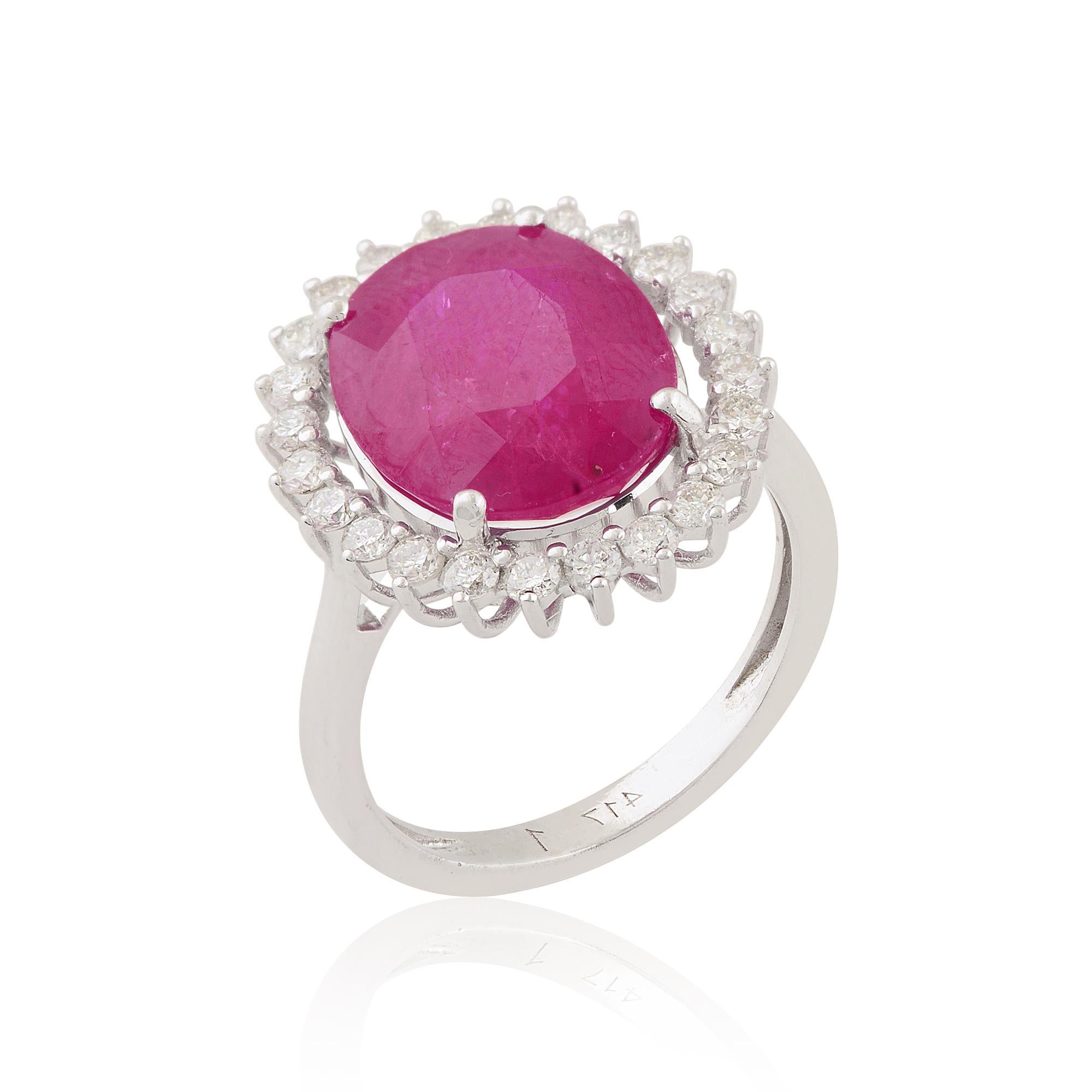 At the heart of this stunning cocktail ring gleams a magnificent oval ruby gemstone, renowned for its rich red hue and exceptional clarity. The ruby, with its vibrant color and inherent allure, commands attention and exudes a sense of prestige and
