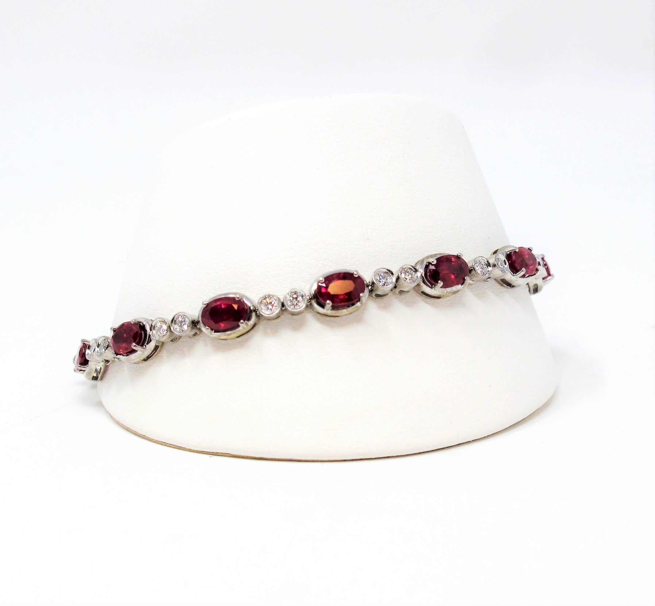 Breathtaking tennis bracelet with a vibrant pop of color. This gorgeous piece absolutely dazzles with its rich red rubies and bright white diamonds. The sleek, strip style design paired with the alternating pattern gives both interest and beauty to