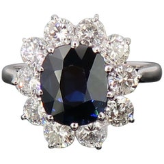Oval Sapphire and Diamond Claw Set Cluster Ring 18 Karat White Gold