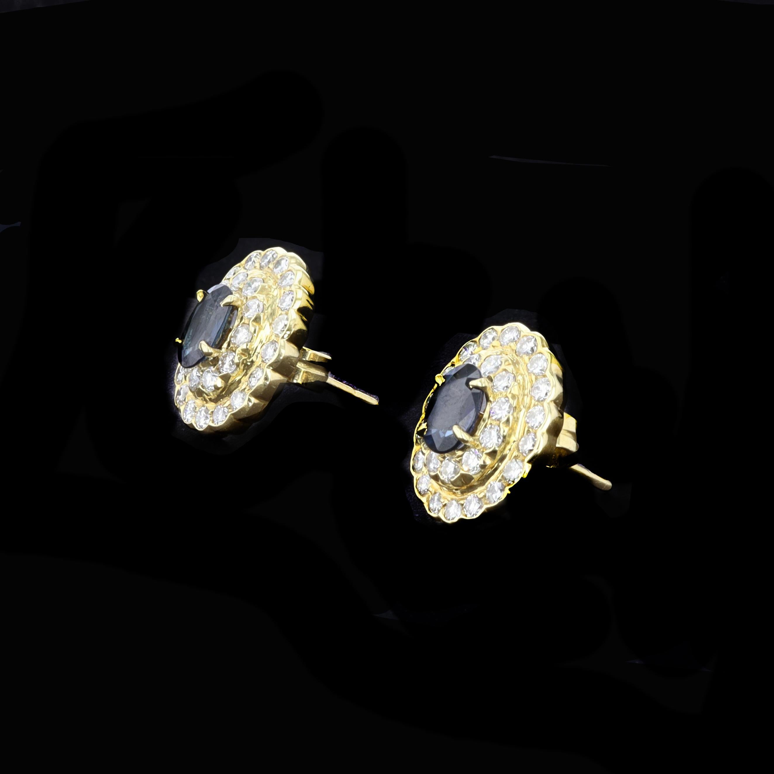 A double halo of 56 round diamonds accents a vivid blue sapphire in this pair of charming on the ear 18K yellow gold earrings. The two oval sapphires weigh 2.35 TWT ctw, and 56 Round Brilliant Diamonds weigh 1.50 TWT ctw.

