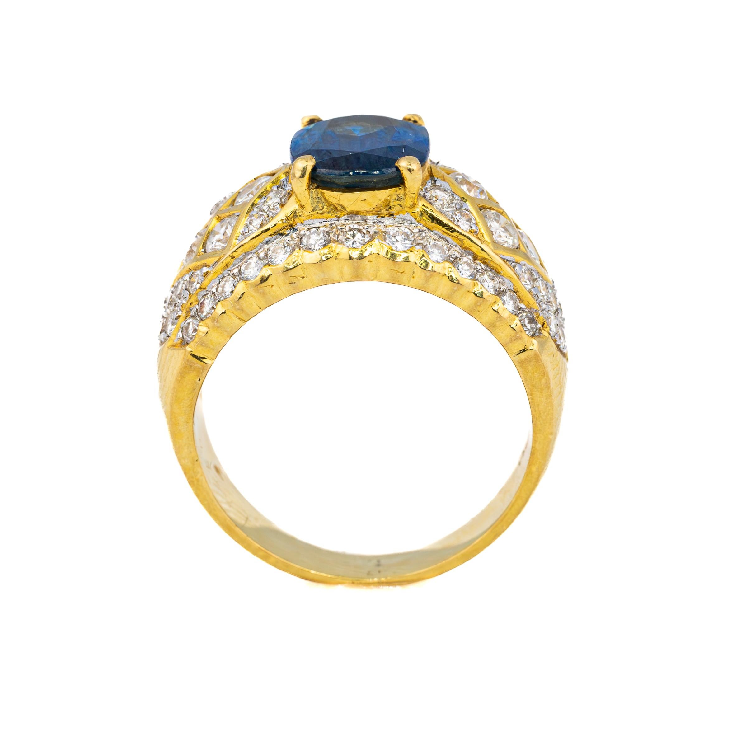 Oval Sapphire and Diamond Gold Cocktail Ring

Centered around a mesmerizing deep blue sapphire, the gemstone is elegantly set in an 18K yellow gold mounting, radiating warmth and brilliance. The captivating sapphire is complemented by an exquisite