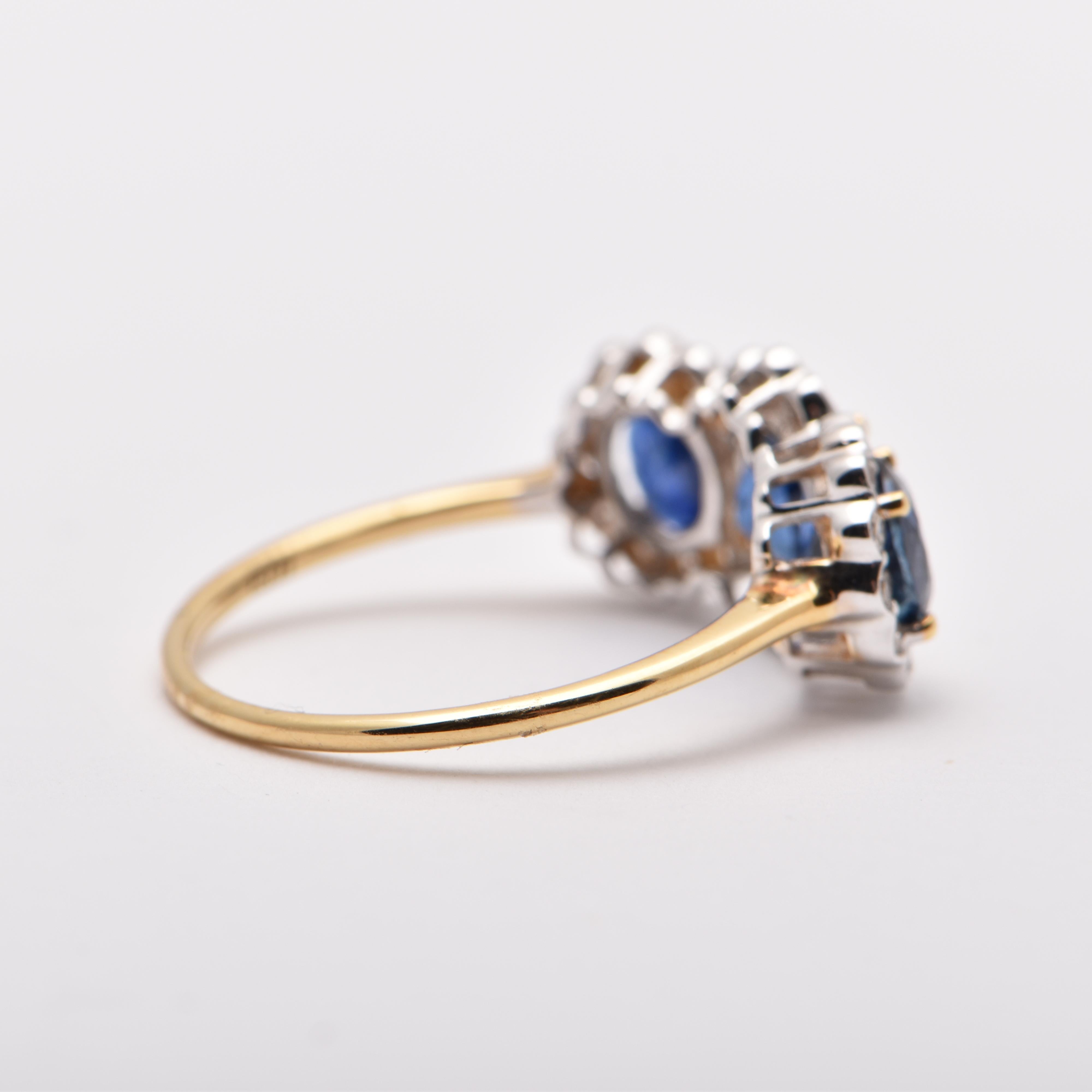 Oval Cut Oval Sapphire and Diamond Halo Trilogy Ring in 18 Carat Yellow Gold For Sale