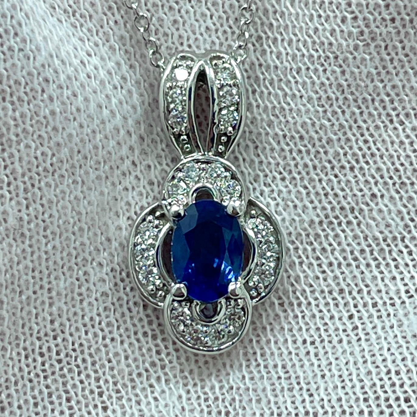 A royal blue .54Ct sapphire in a diamond (0.15Ct) 14K white gold pendant