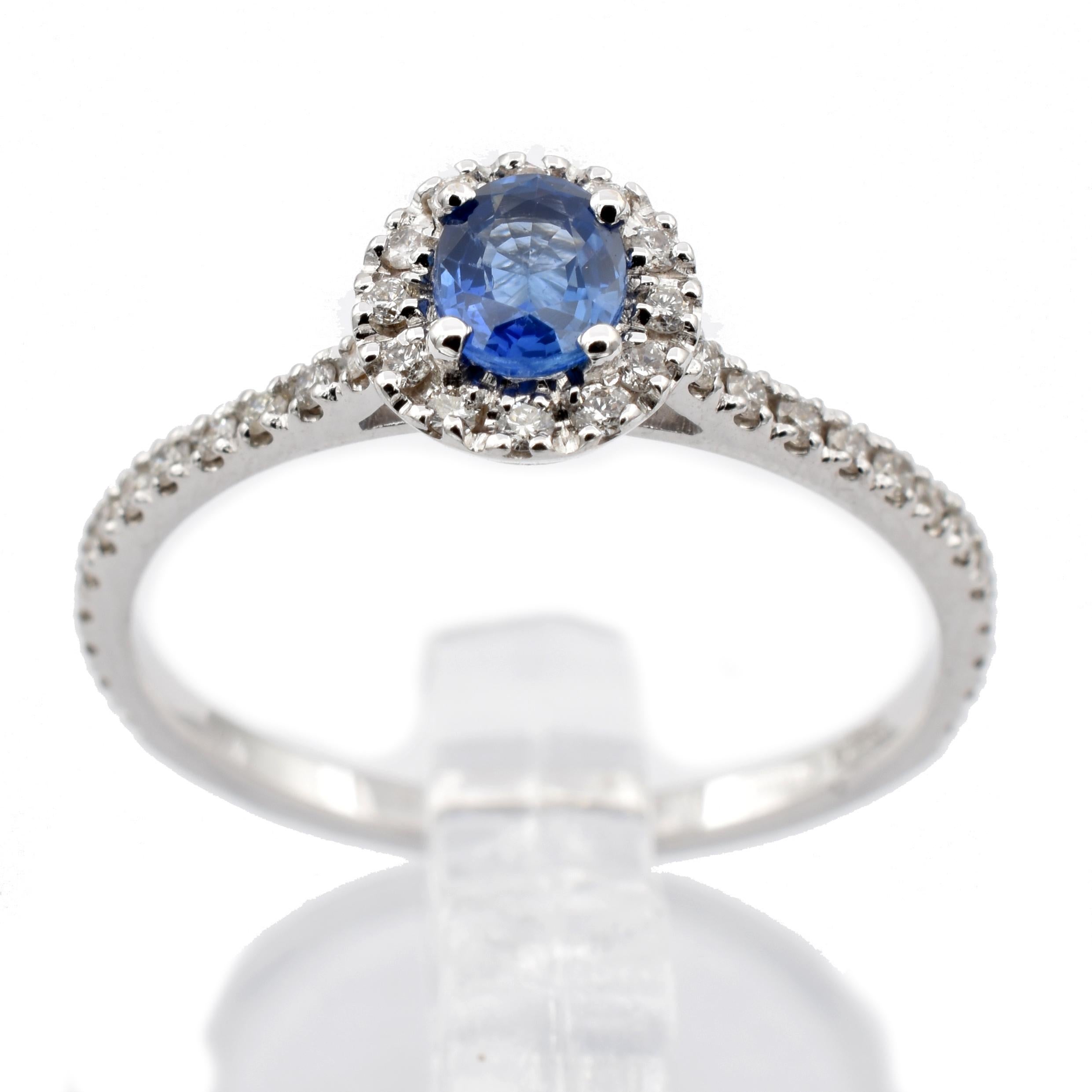 Gilberto Cassola 18Kt White Gold Ring with a Oval Bright Blue Sapphire surrounded by small White Diamonds.
Handmade in Italy in Our Atelier in Valenza (AL)
18Kt Gold g 2.15
Sapphire ct 0.46
Diamonds ct 0.33 
This Ring is sized E 54 (US 6 3/4) and