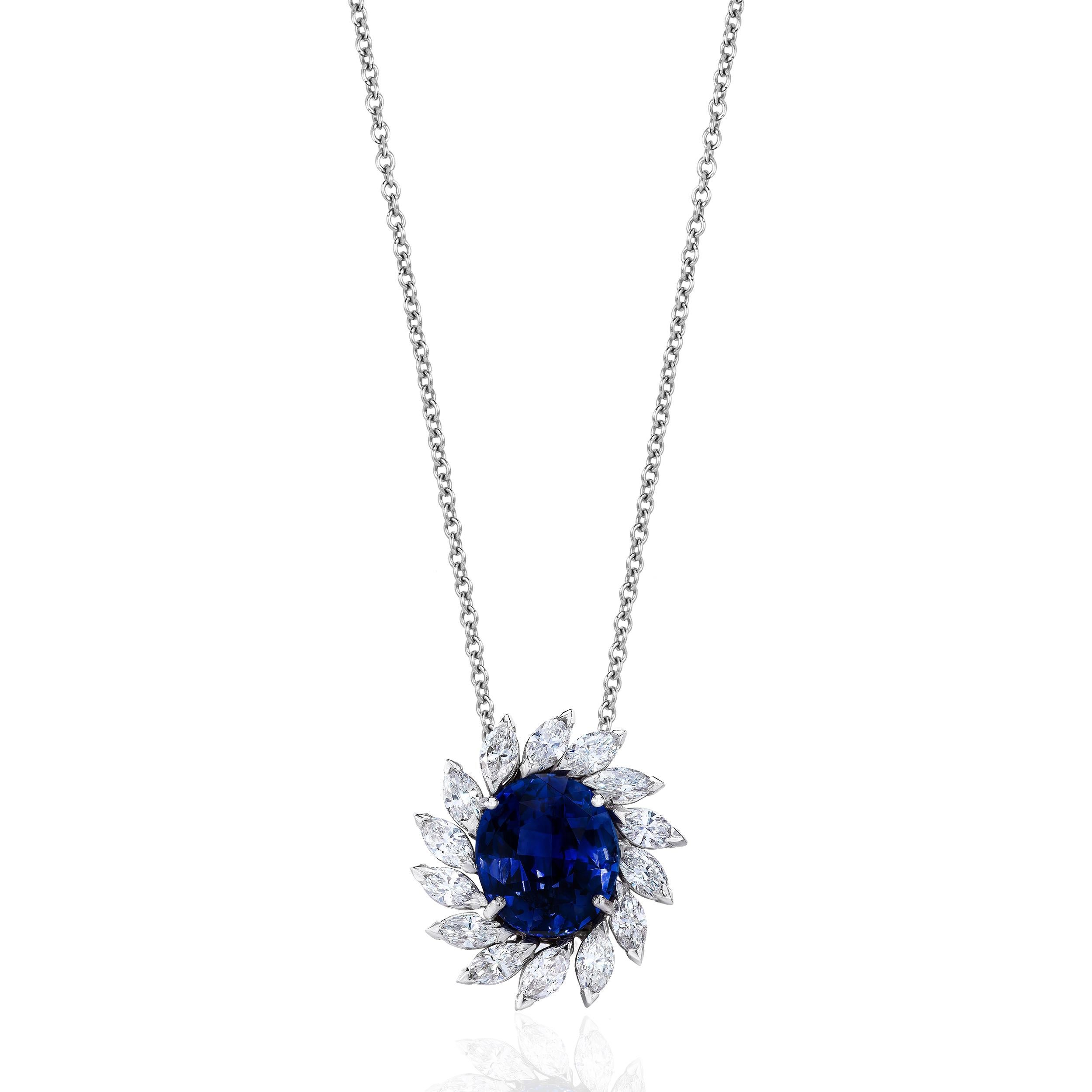 Centered upon a beautiful and rich colored Sapphire weighing approximately 4.50 Carats.
Surrounded by Marquise Cut Diamonds weighing 1.20 Carats.
Set in 18 Karat White Gold.

Jump chain measuring 18-20 inches.
