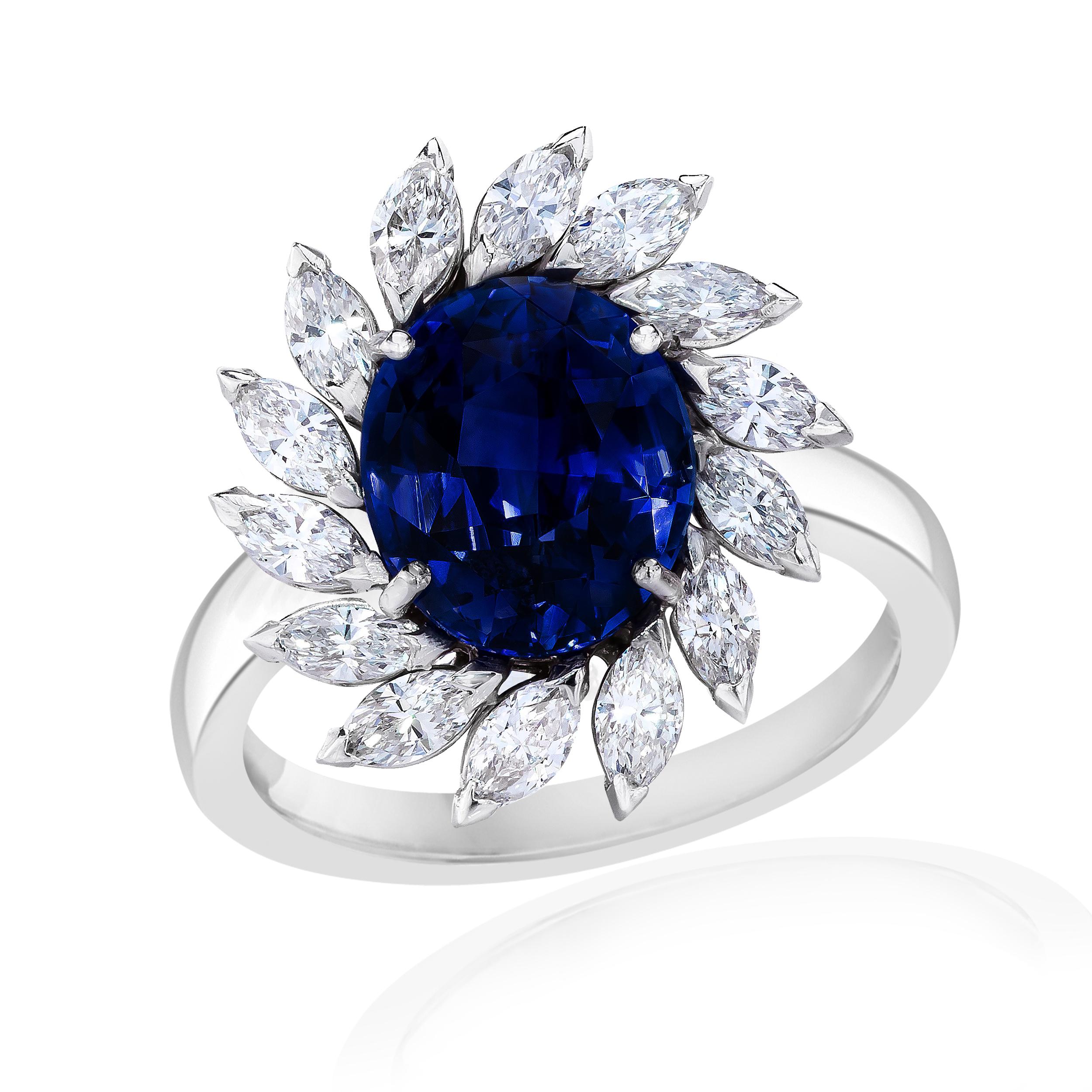 Centered upon a beautiful and rich colored Sapphire weighing approximately 4.50 Carats.
Surrounded by Marquise Cut Diamonds weighing 1.20 Carats.
Set in 18 Karat White Gold.
