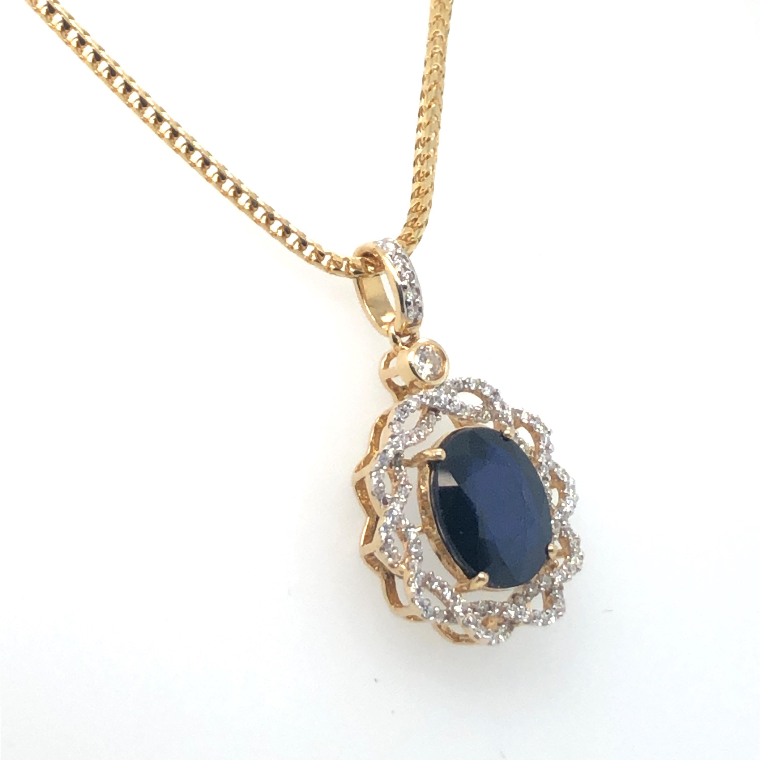 Oval Sapphire & Diamond Pendant 14K Yellow Gold on 18K Yellow Gold Chain. The pendant features an oval cut 4.30ct Sapphire, accented by brilliant cut diamonds. The pendant is on a 16 inch chain that is 1.6mm wide. 
10 Grams
1.25