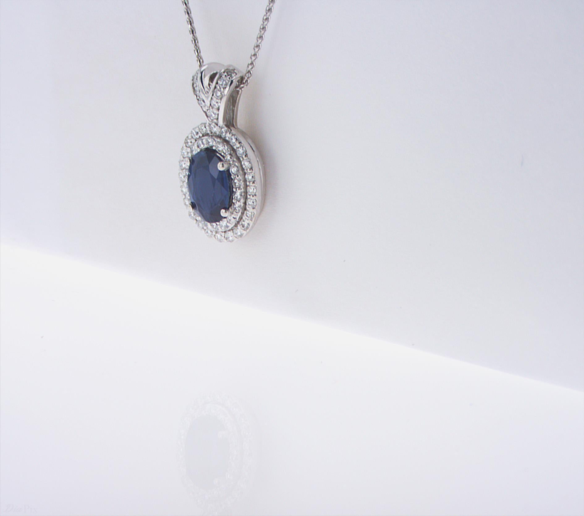 1.07ct Oval Sapphire with 2 rows of Diamond Halo, 0.28ct total weight. 14k White Gold.
