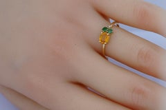 Oval sapphire, tsavorite and diamonds 14k gold ring.