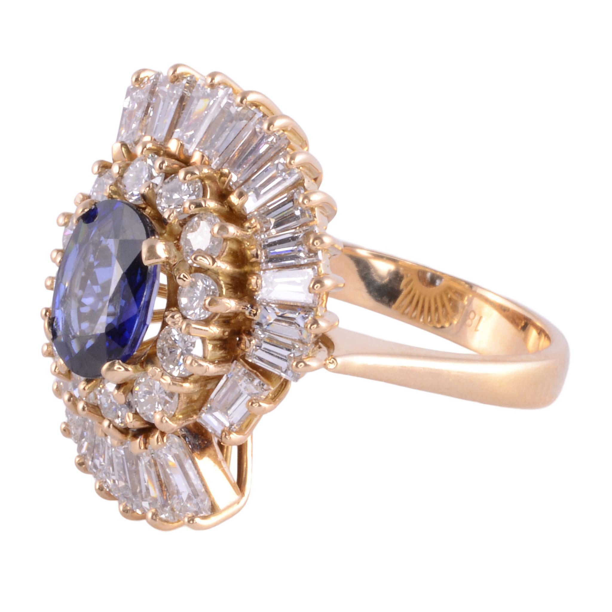 Estate oval sapphire & VS diamond 18K ring. This custom ring in 18 karat yellow gold features a 1.45 carat oval sapphire with fine bright blue color. The sapphire is accented with 2.75 carats of round brilliant and baguette cut diamonds with VS