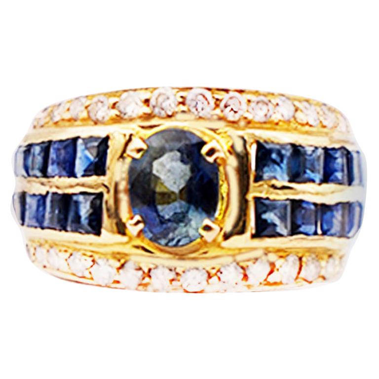 Oval Sapphire with Princess Channel and Diamond 18 Karat Band Ring For Sale