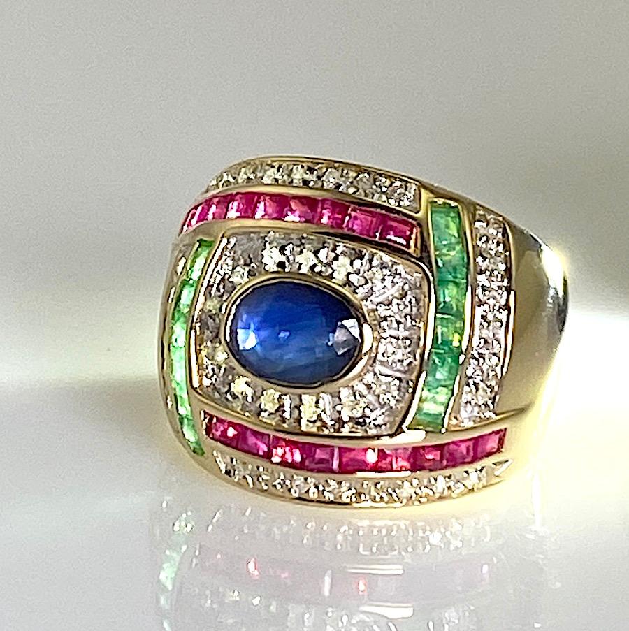 Oval sapphire with princess cut emeralds and rubies 14k yellow gold 7.20gm  .16pt round diamonds  Size 7
