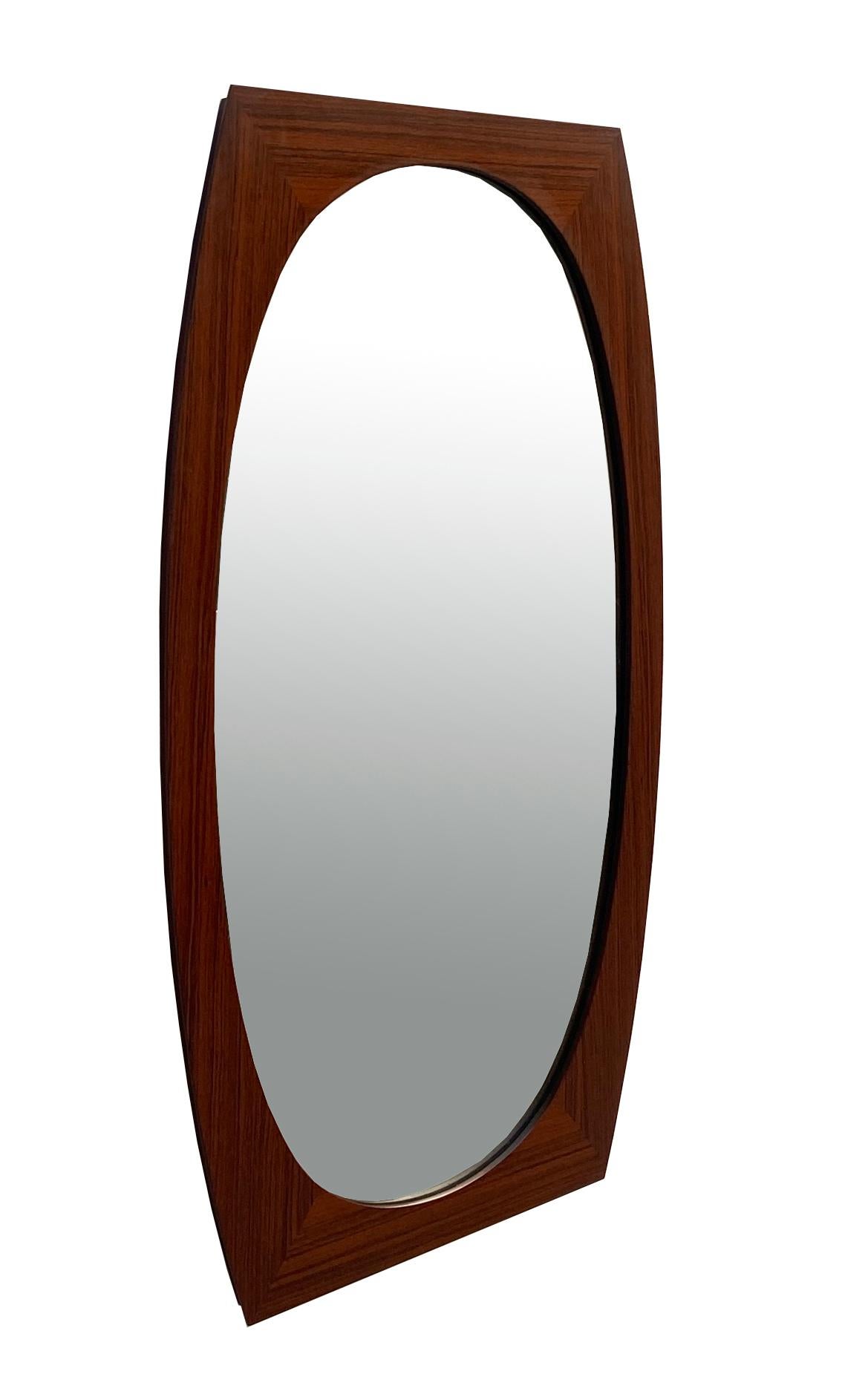 A good sized Scandinavian wood elliptical mirror, circa 1960. Nicely framed with a curved solid wood frame.