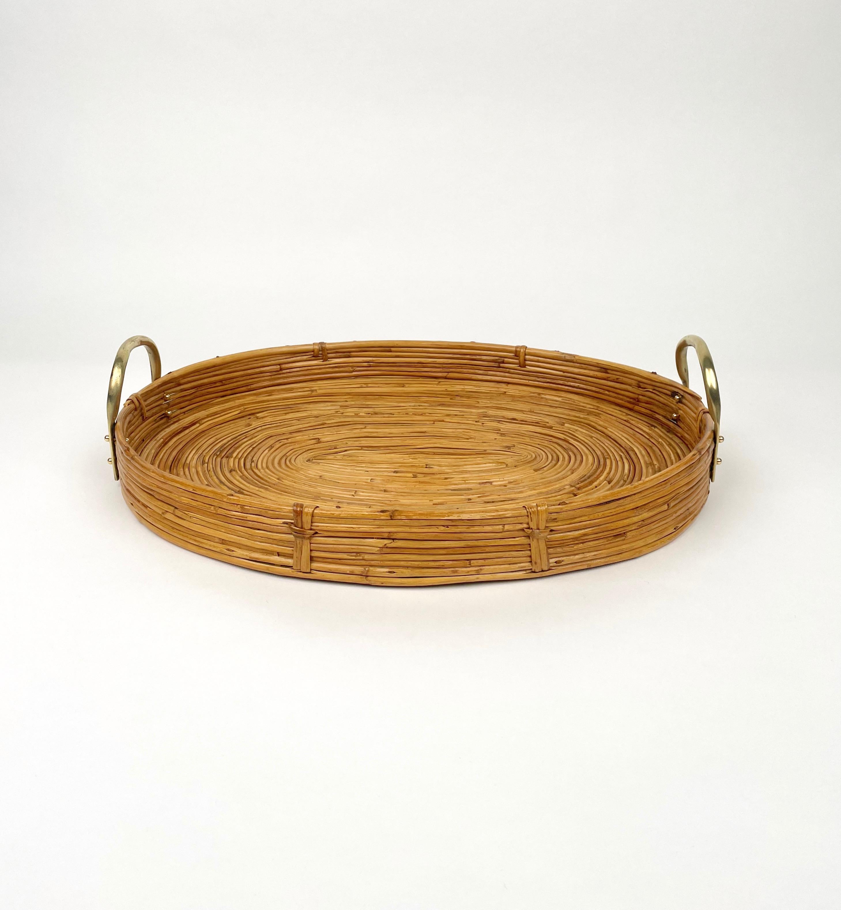 Beautiful 1970s Italian Mid-Century Modern serving cocktail bar tray with polished brass handles . Made of rattan and bamboo, this charming piece is in the typical style where the organic beauty of the woven materials is timeless and classic, making