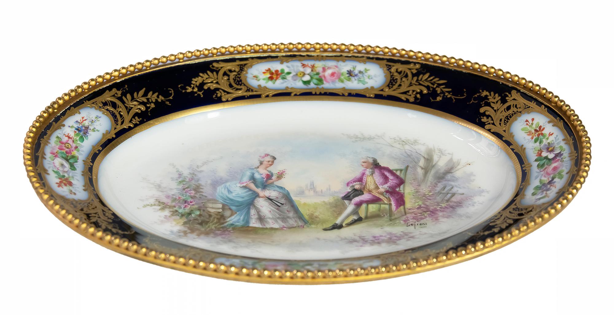 Oval decorative antique French Sevres porcelain plate.
The royal blue border with four panels painted in flowers and beaded ormolu mount. The central hand painted scene is singed Lefranc.
Marked on the bottom: Louis Philippe mark 1844, green