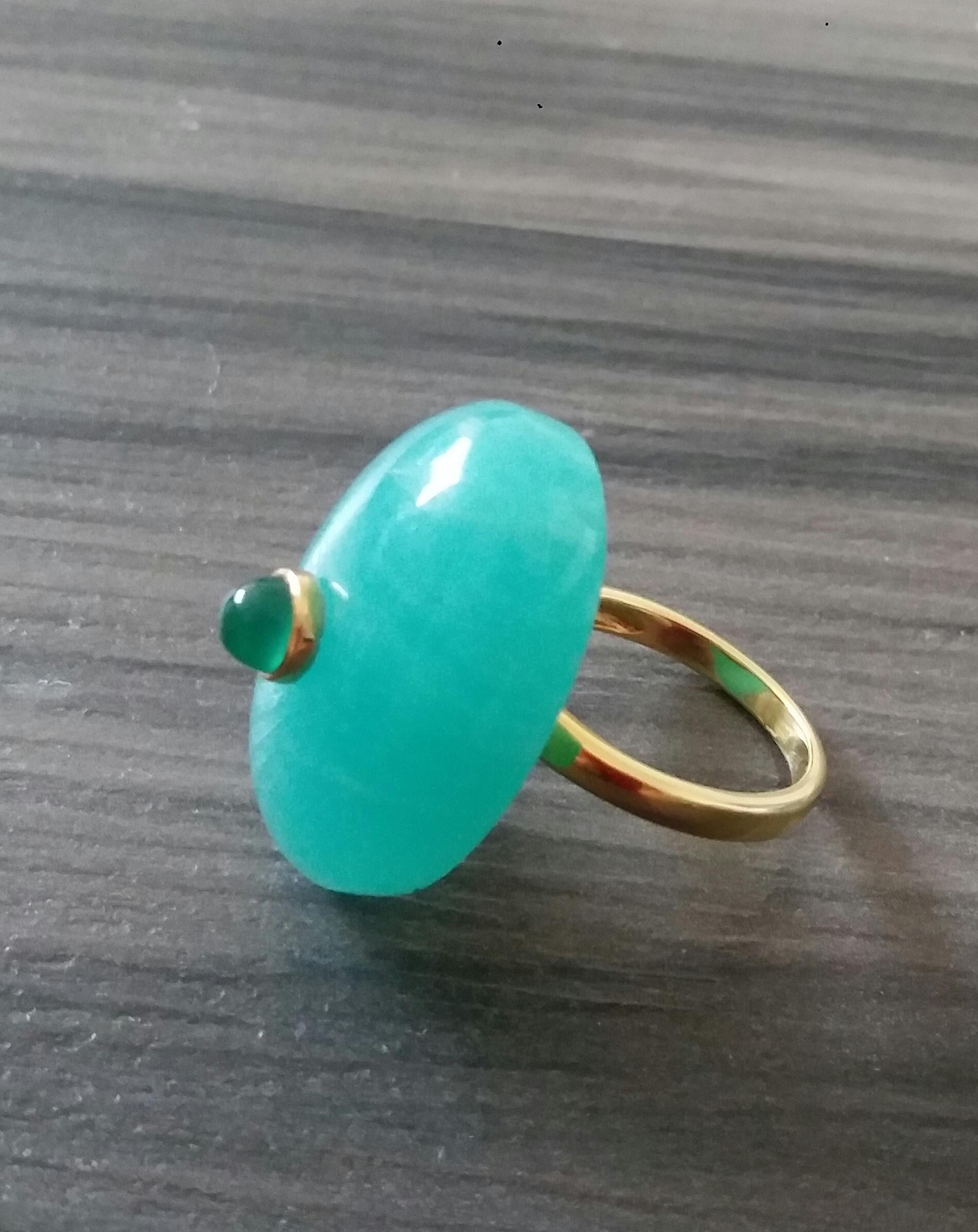 Unique ring with a Big Oval Shape Natural Extra Quality  Amazonite  Cab measuring 28 mm. x 20 mm x 9 mm. with a Round Emerald Cab measuring 6 mm in diameter set in 14 kt yellow gold bezel...Ring shank is also in 14 kt  solid yellow gold now in