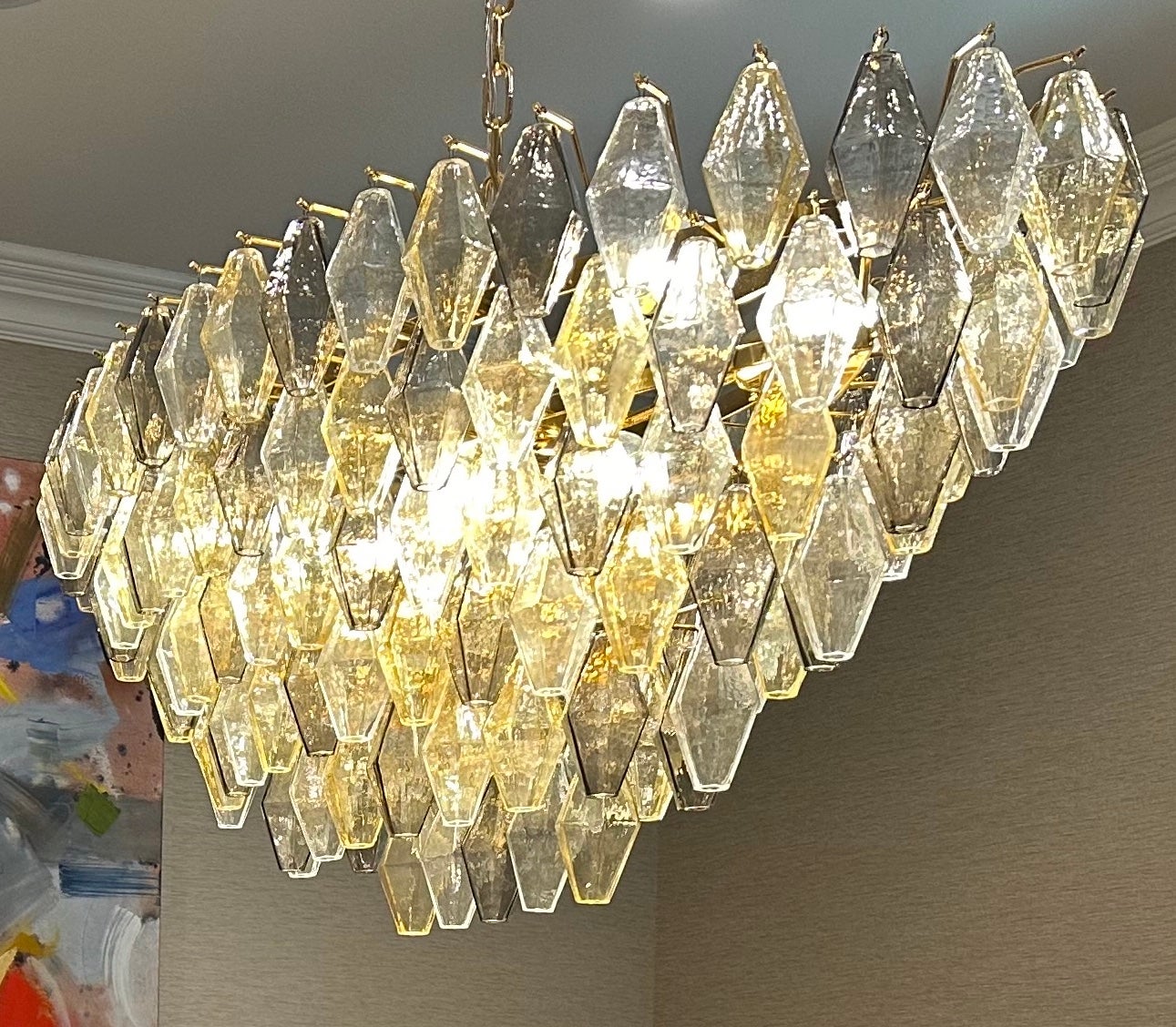 This chandelier consists dozens of hand blown gray, amber ,  and clear 
