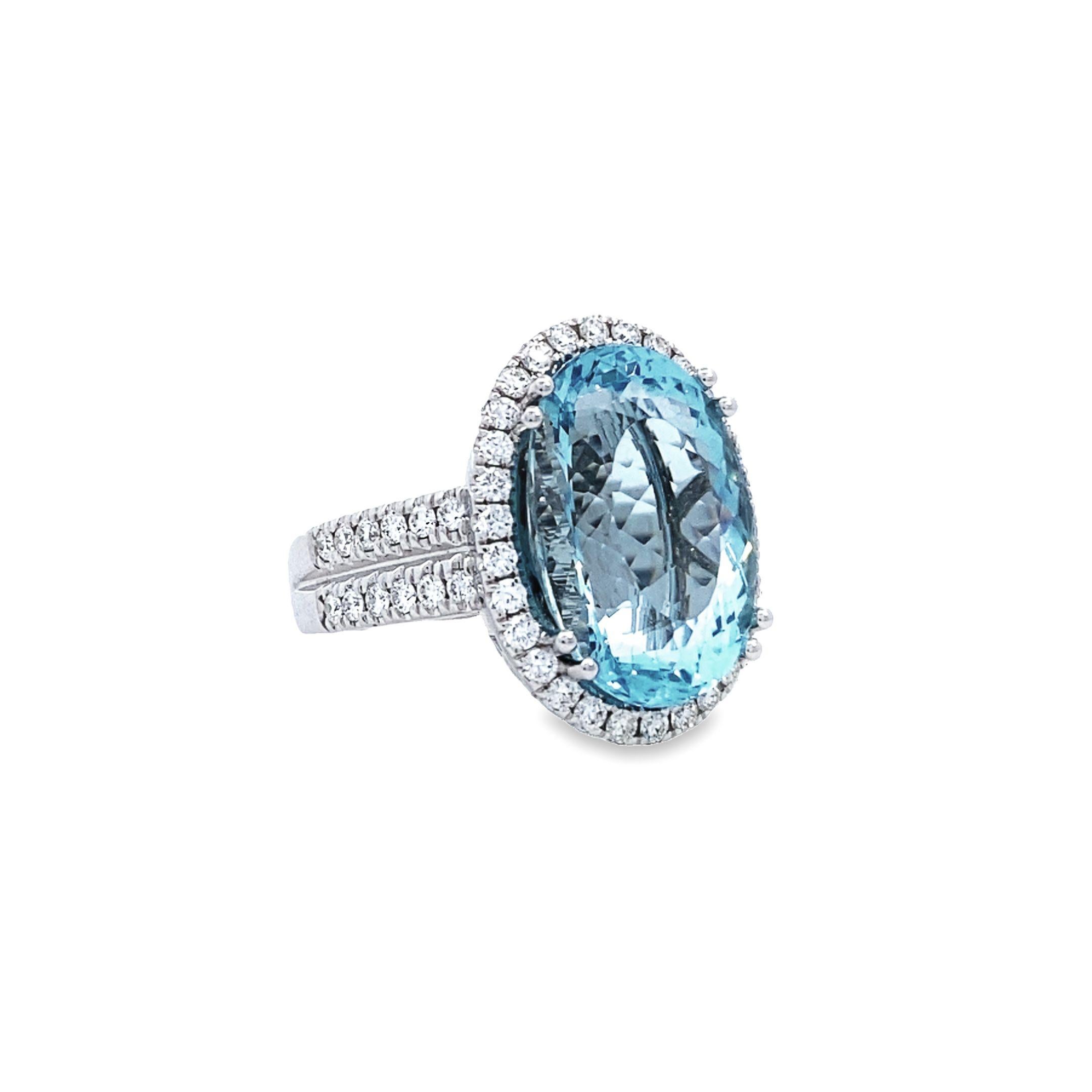 This exquisite ring boasts a classic and traditional style, crafted from 14k white gold with a stunning prong-set design. The focal point of this timeless piece is a mesmerizing 10.91 carat blue oval aquamarine center stone, exuding a captivating
