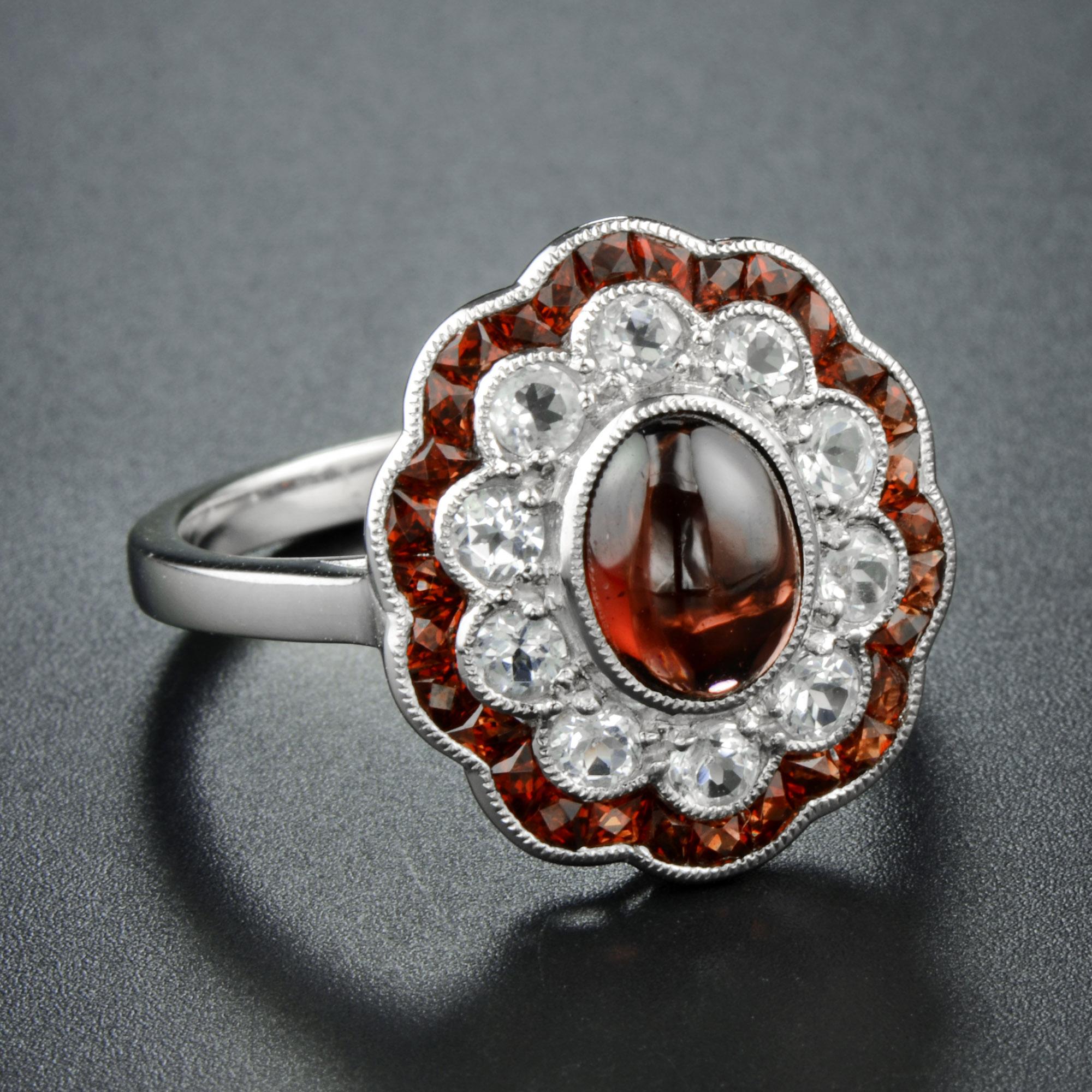 A breathtaking garnet and diamond flower ring, it’s artfully handmade of luxurious 14K white gold , and high-polished for shimmering smooth finish. The center features oval cabochon-shape natural garnet of 1.70 carats that is highlighted by icy