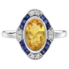Anillo de Oro Blanco Estilo Art Decó con Halo de Diamantes y Zafiro Azul y Citrino de Forma Ovalada
