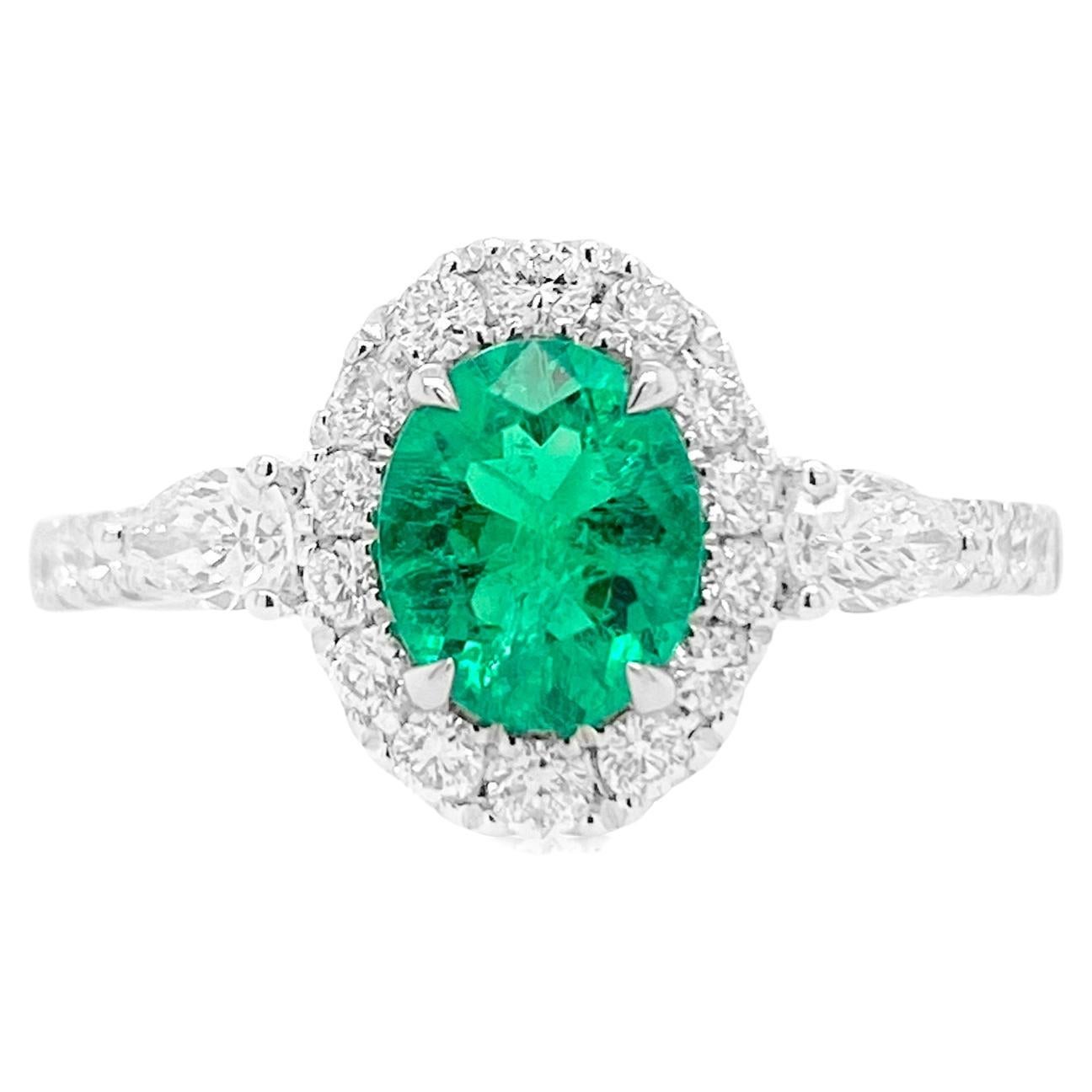 Oval Shape Colombian Emerald Ring with Pear shape white Diamonds For Sale