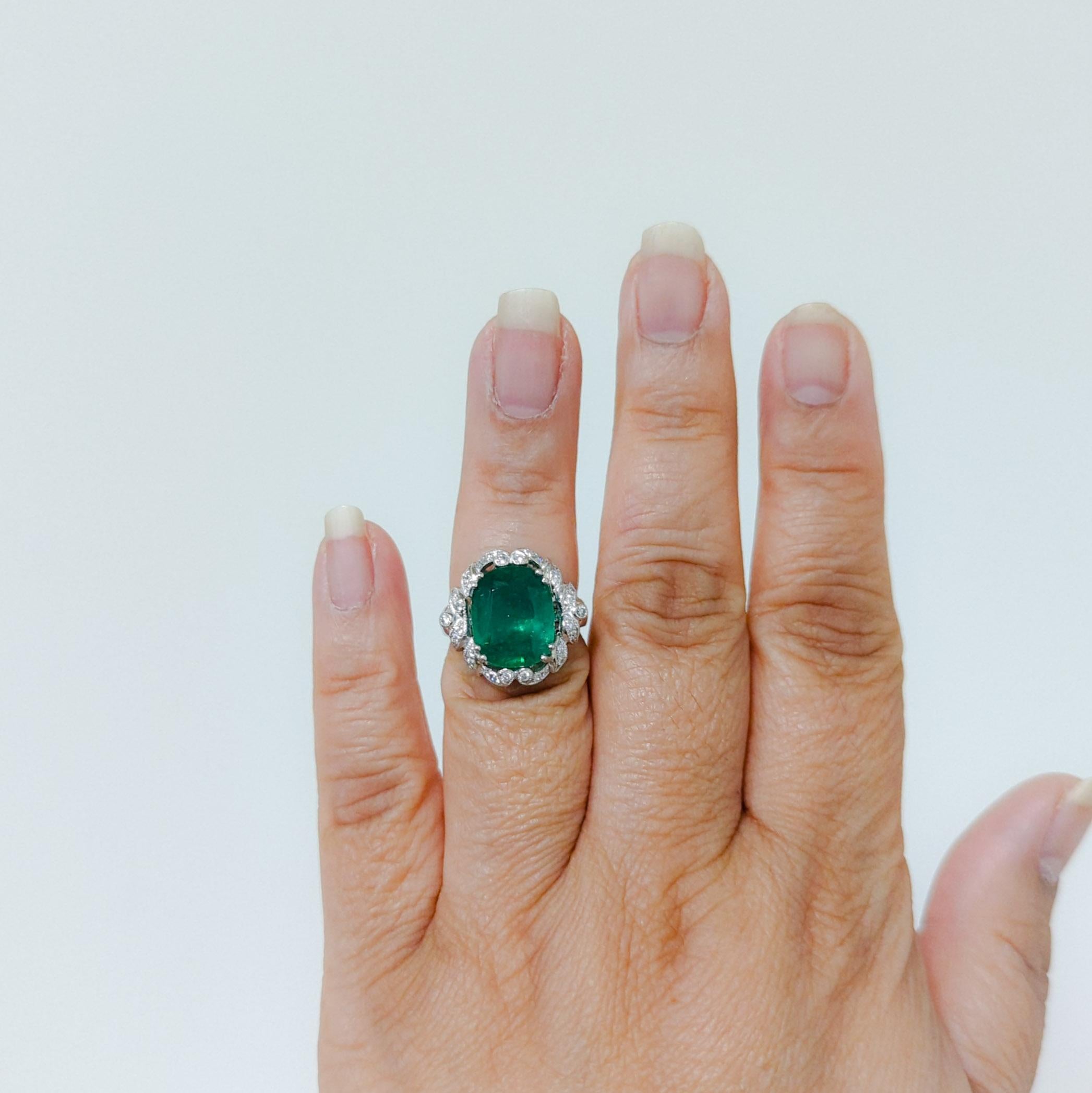 Beautiful 5.61 ct. emerald oval with good quality white diamond rounds.  Handmade in 18k white gold.  Ring size 5.75.