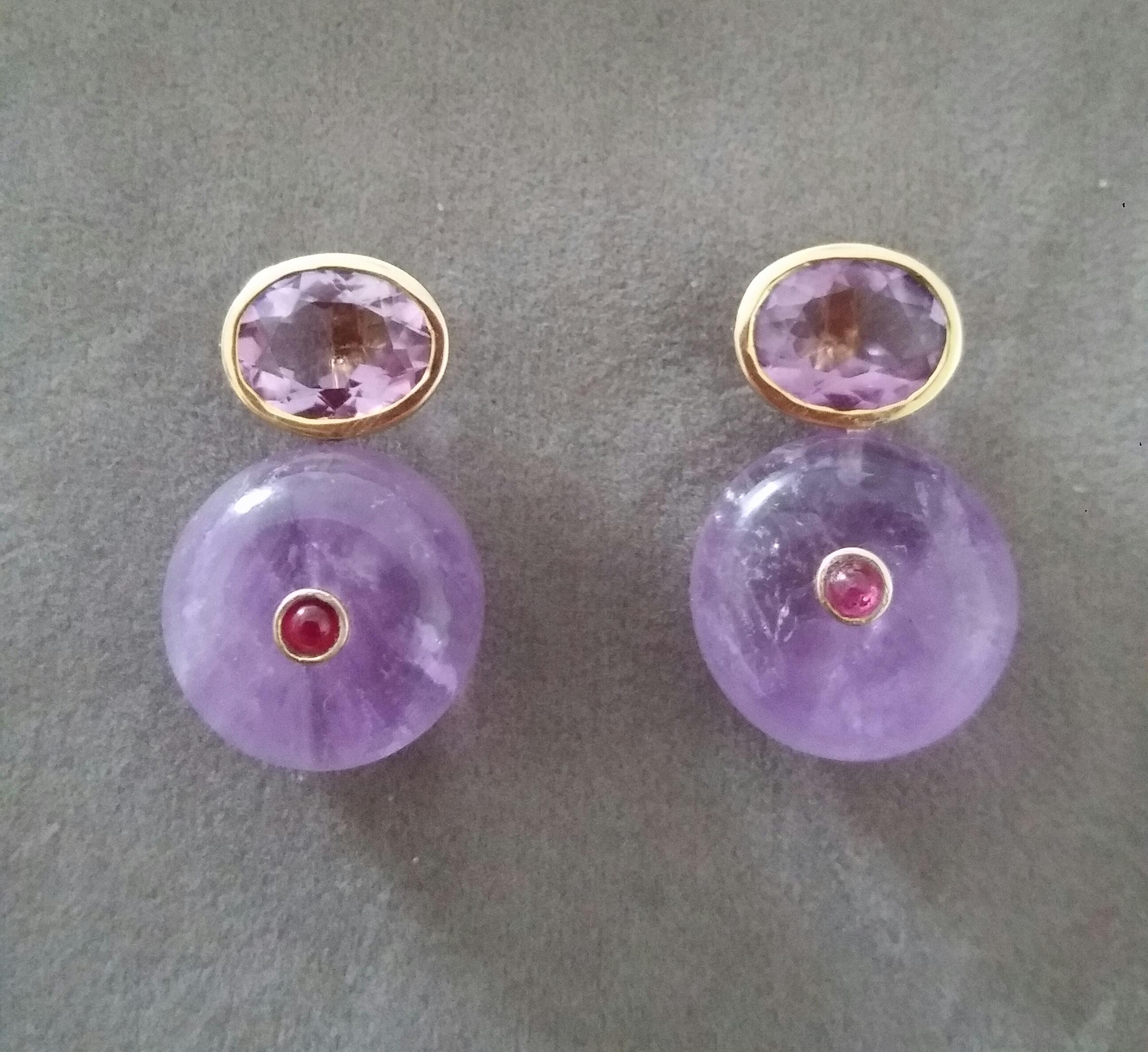 Simple chic stud earrings with a pair of Oval Cut Amethyst measuring 8mm x10 mm set in solid 14 Kt. yellow gold on the top and in the lower parts 2 Round Plain Wheel Shape Amethyst  16 mm .in diameter with a small round Ruby cab in the center
In