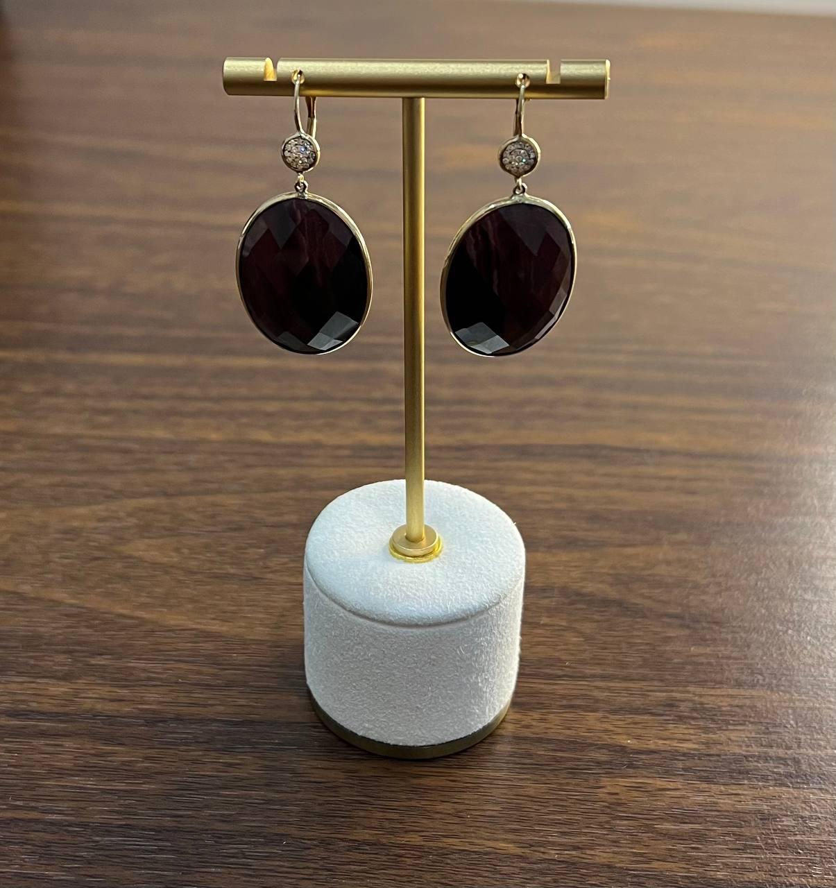 Elegant oval drop earrings. These earrings feature large, smooth oval pendants of Labradorite with a deep, rich brown hue. Above each pendant, a small, round bead adds a touch of contrast and texture. A statement piece for any occasion. Natural