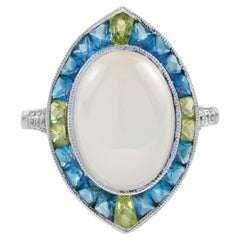 Bague de cocktail de forme ovale en pierre de lune, diamant, topaze bleue et péridot de style Art déco