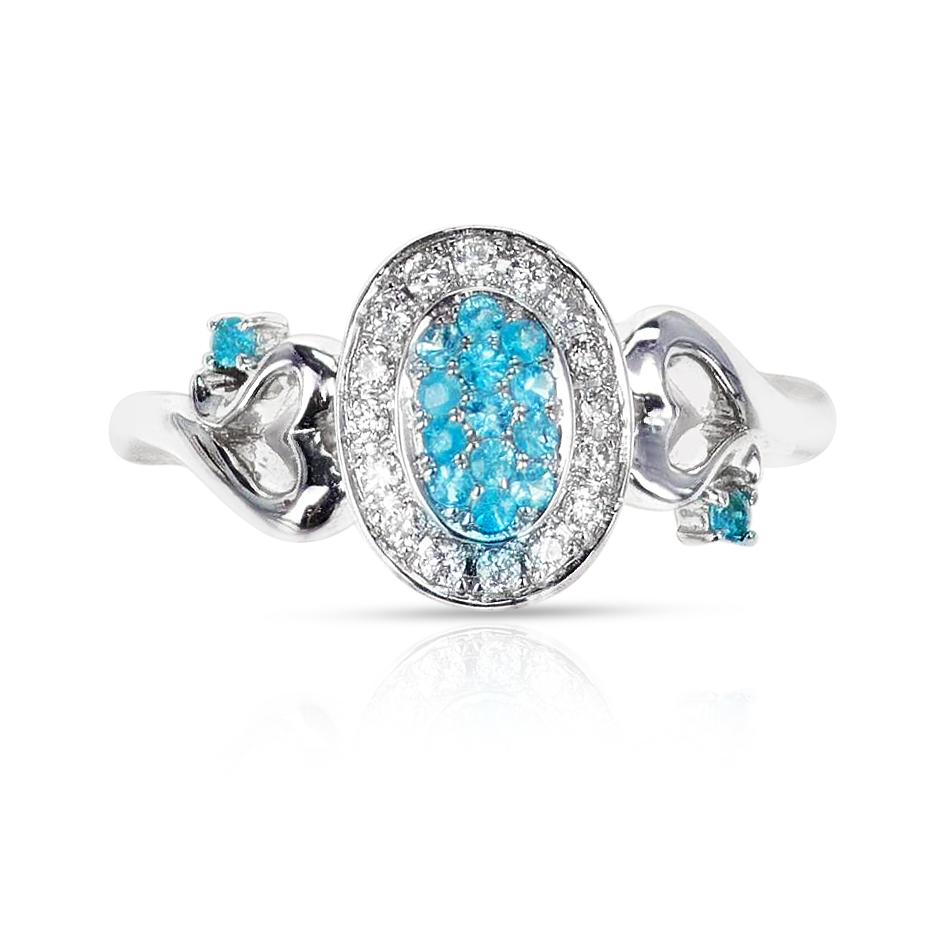 An Oval Shape Ring with Brazilian Paraiba Tourmaline and Diamonds with Hearts. The ring is made in 18 Karat White Gold. The weight of the Paraiba is 0.18 carats and the diamond weight totals appx. 0.18 carats. The weight of the ring is 4.09 grams.