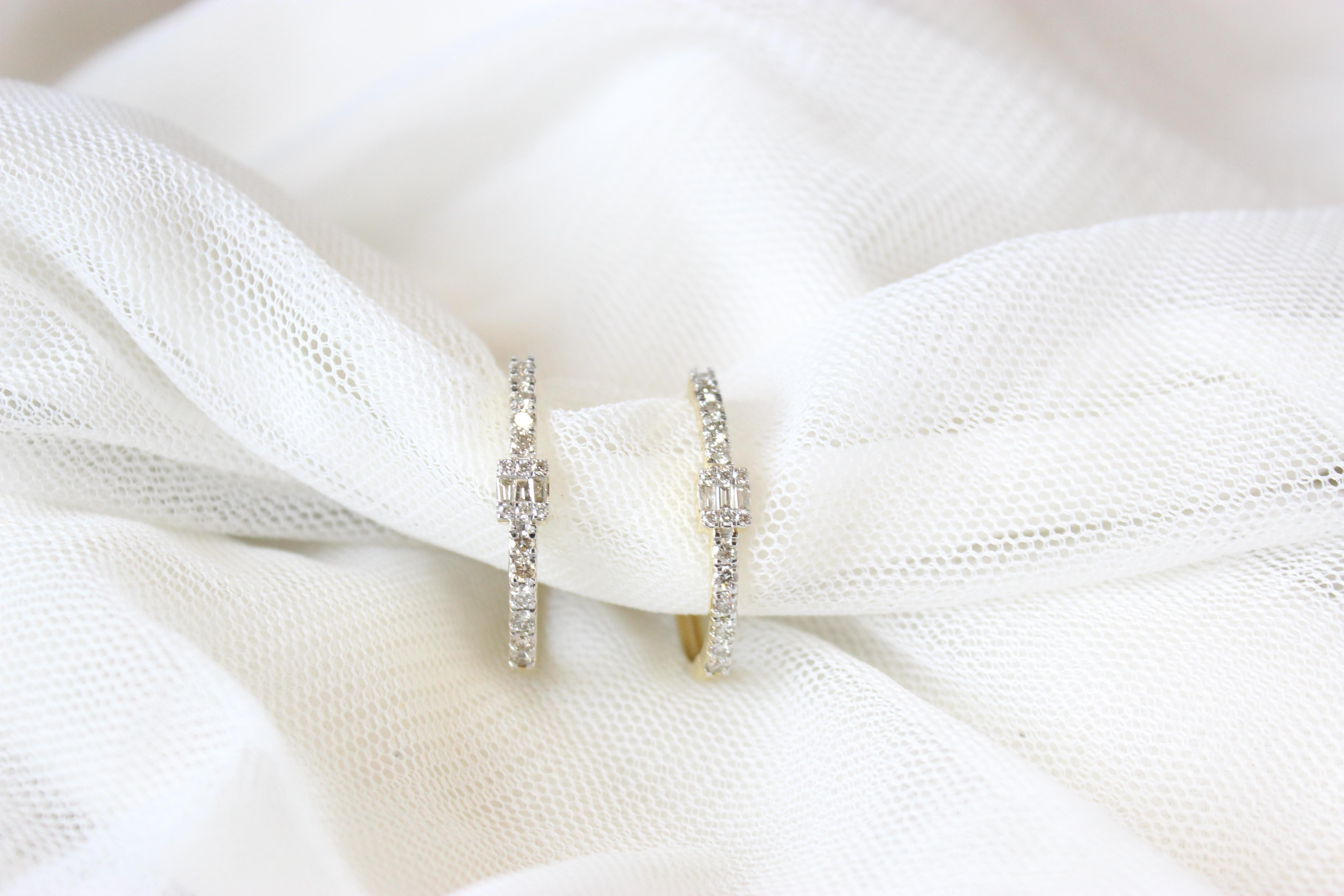 This exquisite hoop earrings are a stunning example of timeless elegance and modern sophistication. Crafted from lustrous 18K solid gold, their oval shape provides a unique twist on the classic round hoop design. The hoops are adorned with a