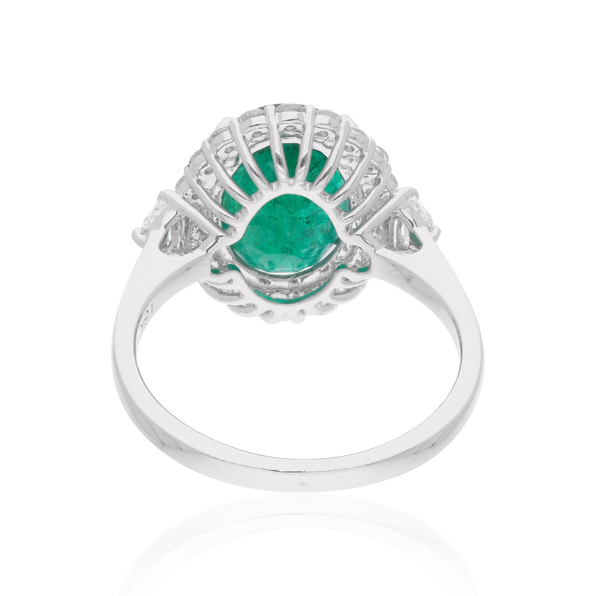 Indulge in the opulent allure of this Oval Shape Zambian Emerald Gemstone Cocktail Ring, elegantly set in 14 Karat White Gold. This exquisite piece exudes sophistication and timeless charm, perfect for those who appreciate the finer things in