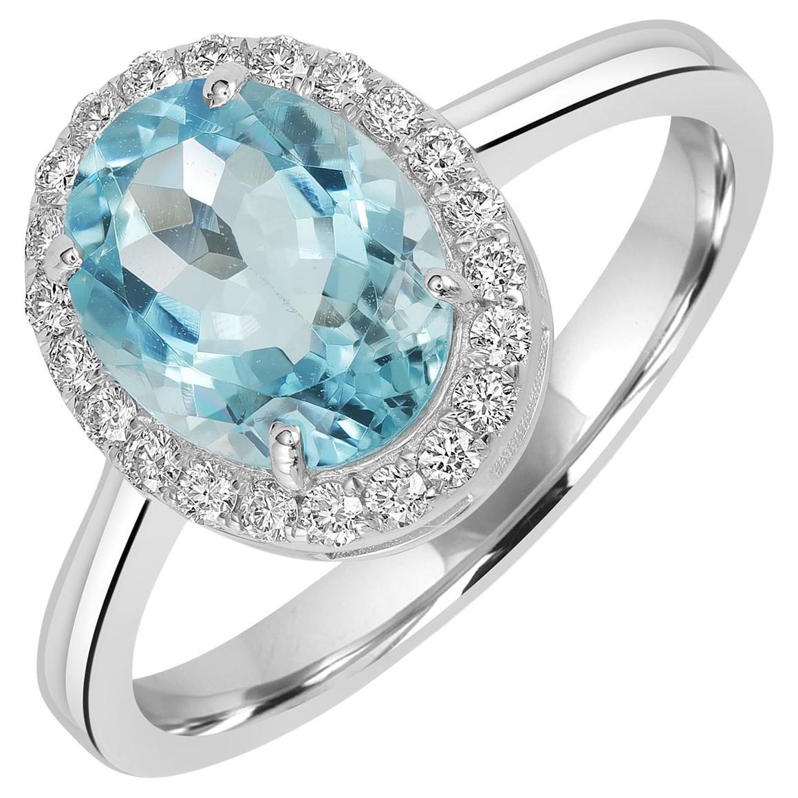 Bague en or blanc 18k avec aigue-marine de forme ovale rehaussée de diamants