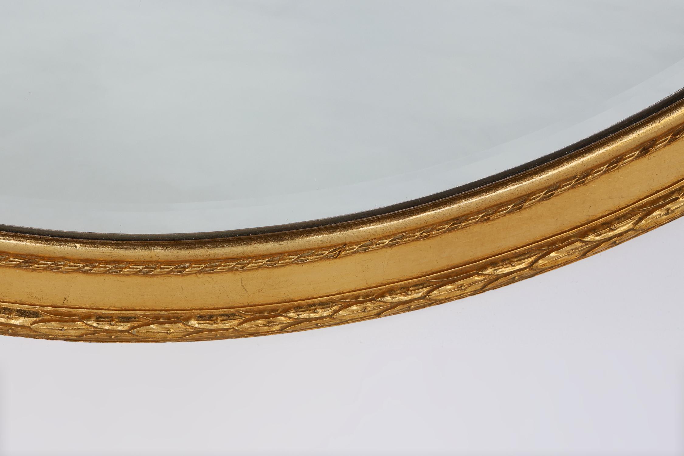 Baroque Revival Oval shaped carved gilded Baroque mirror with beveled glass, Belgium For Sale