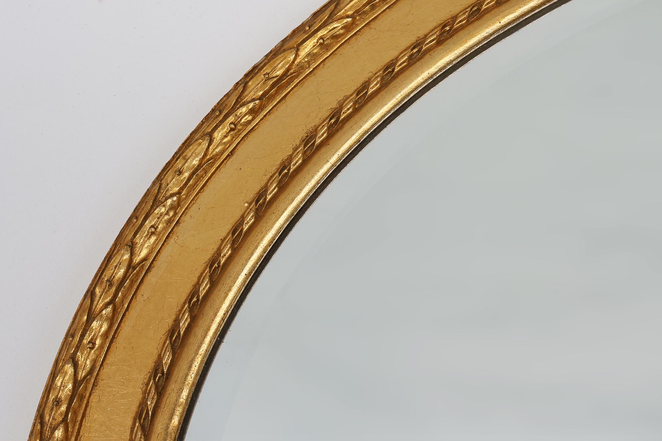 Belgian Oval shaped carved gilded Baroque mirror with beveled glass, Belgium For Sale