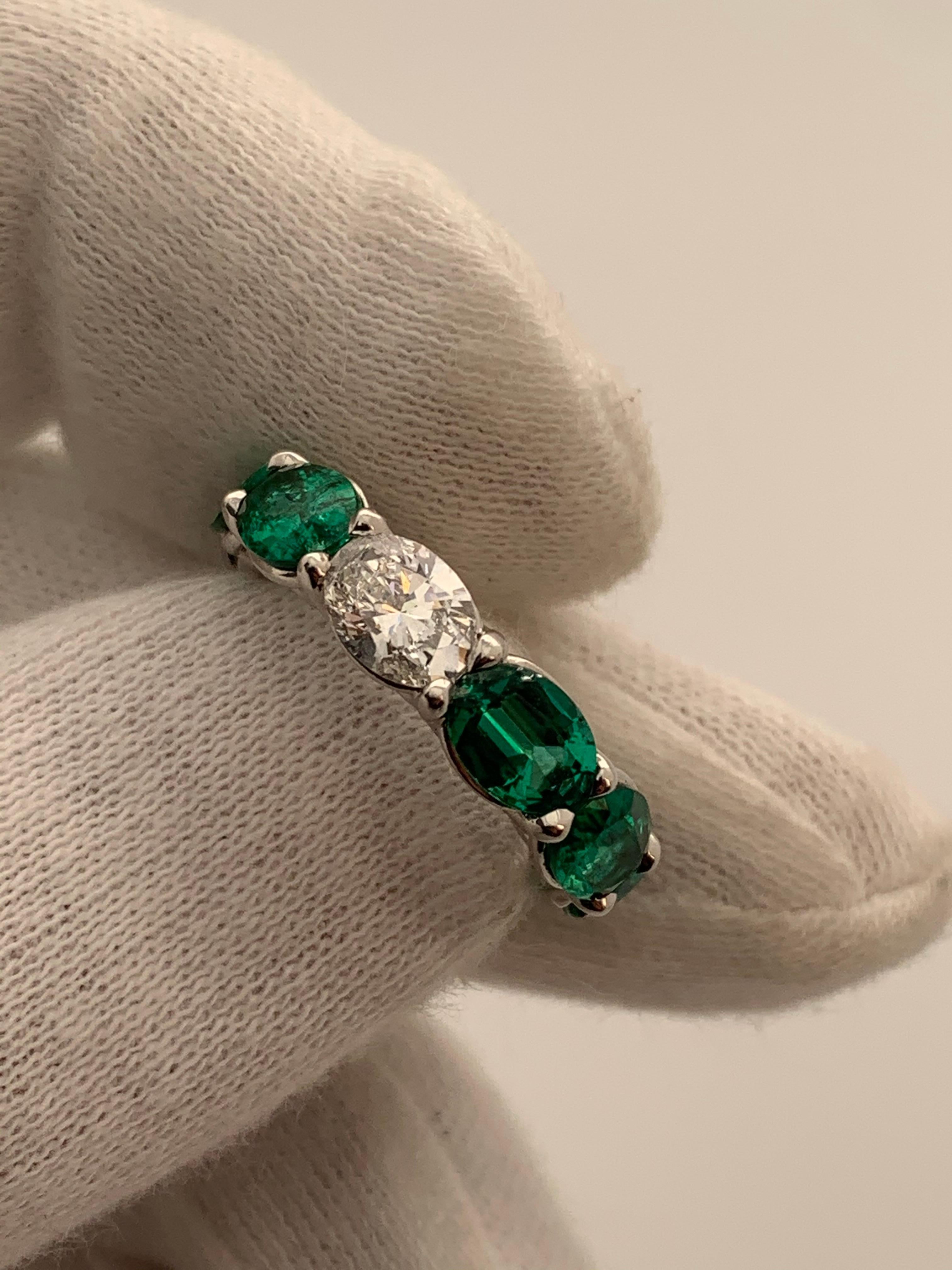This beautiful Ring features 9 Fine Oval Shaped Emeralds weighing 6.18 Carats with 1 Oval Diamond weighing 0.71 Carat that can be worn Diamond side up or down. Set in Platinum.
Finger Size 5.
Can be resized.
Also available in other Gemstones.