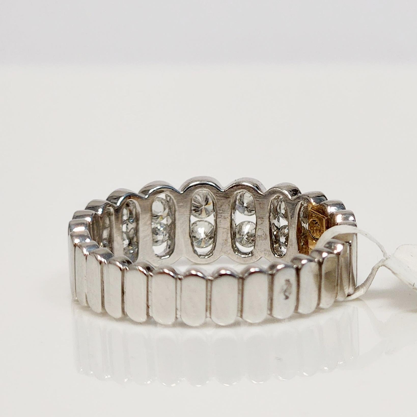 This stunning Oval Shaped Eternity Ring is a true beauty. It features seven oval bezels, each holding pairs of two round white diamonds, totaling 0.39 carats of weight. The diamonds are set in a sleek and elegant 18K white gold band, creating a