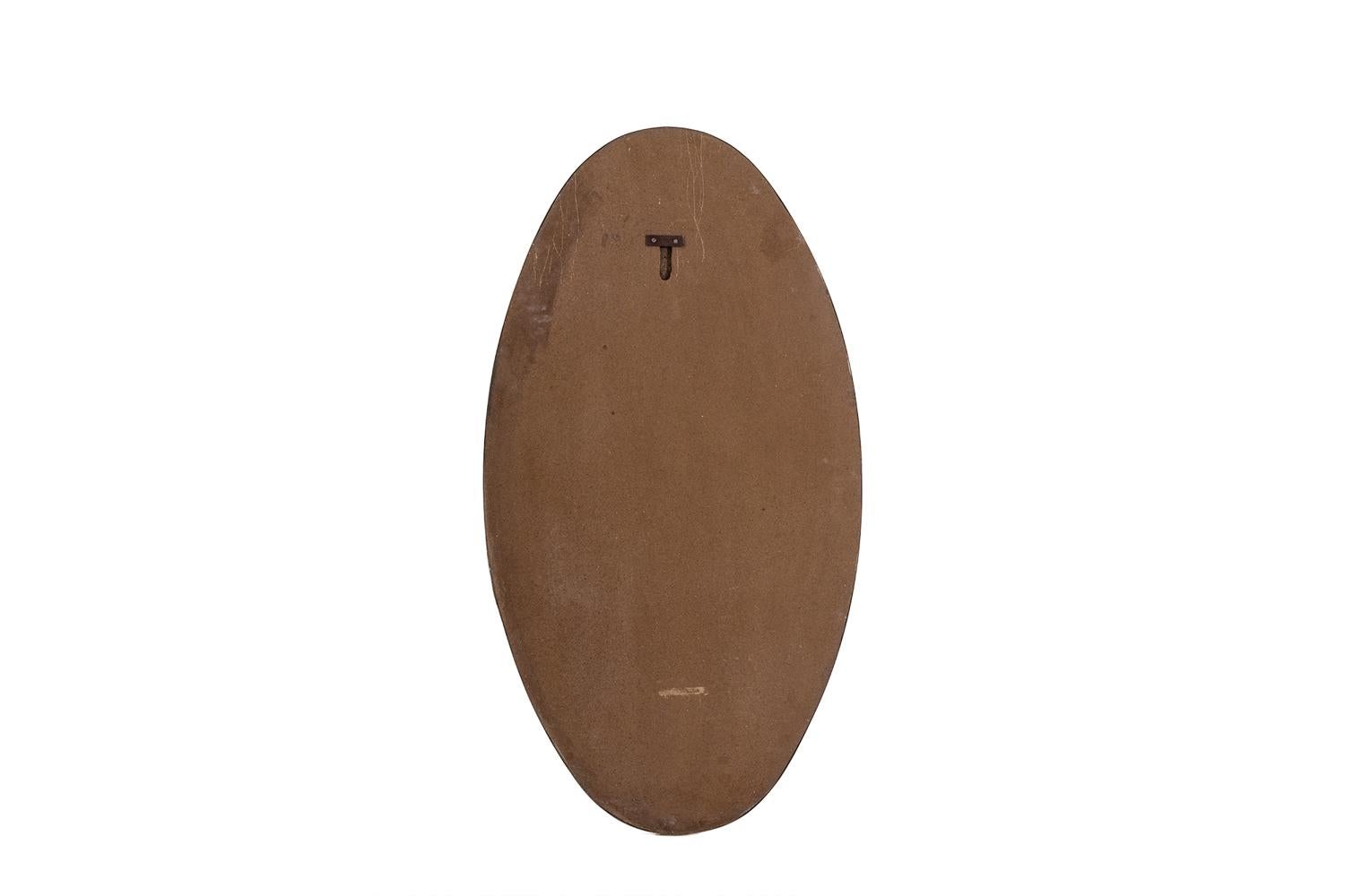 Oval-shaped mirror set with a gilded brass.

Italian work realized in the 1970s.

Dimensions: H 109 x W 63 x D 2,5 cm

Reference: LS6260509M