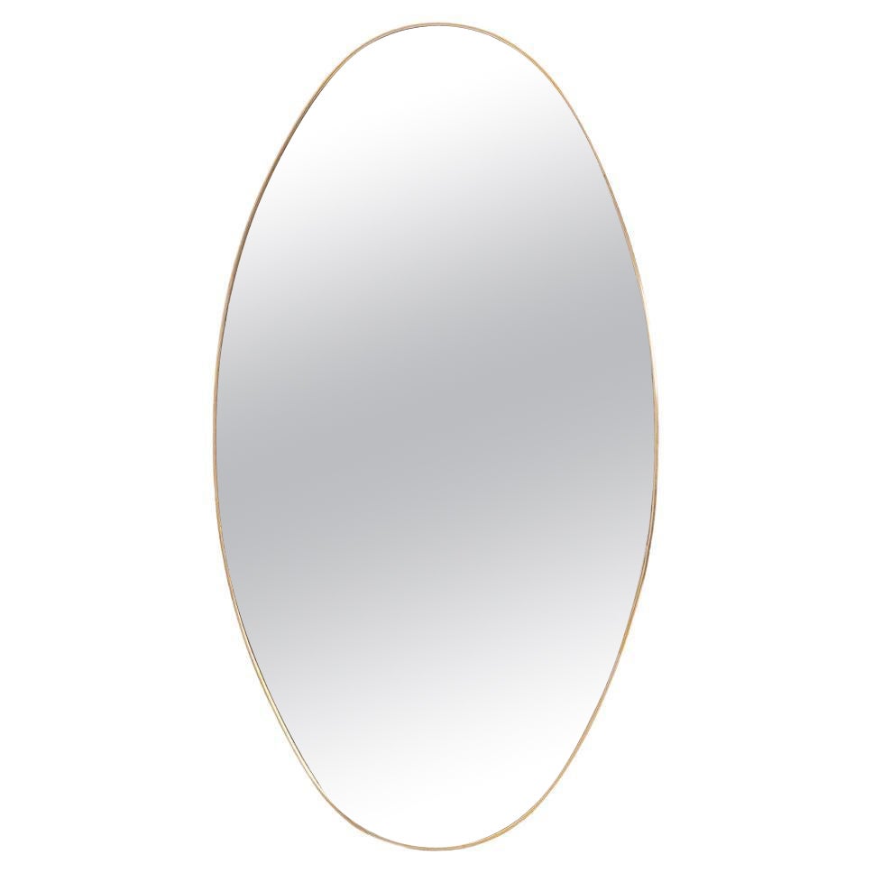 Oval-shaped mirror set with a gilded brass. 1970s.
